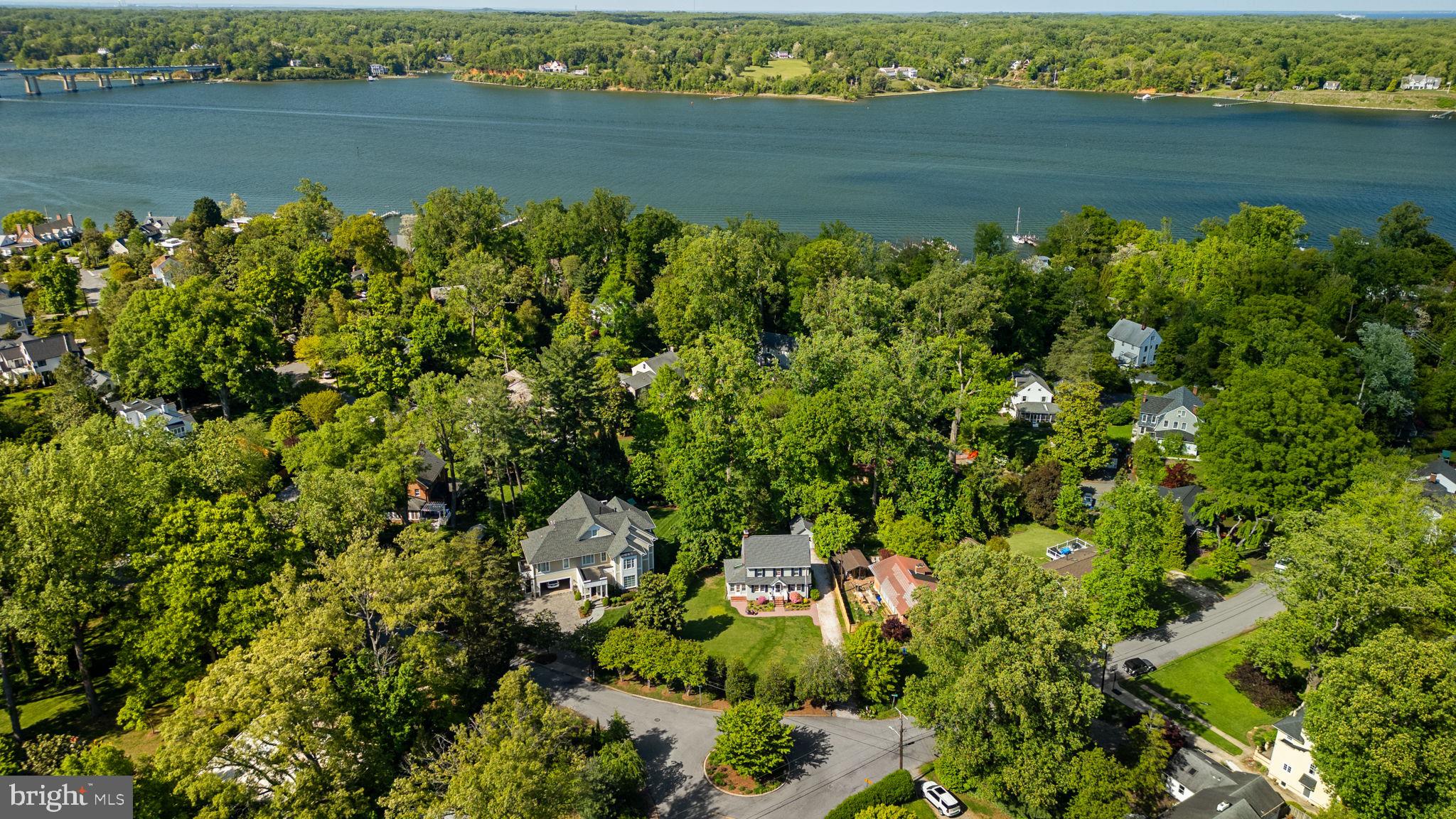 Welcome to 202 Wardour Drive! This classic 1940 Dutch Colonial offers timeless character, generous living space, and an unbeatable Annapolis location. Situated on a quarter acre lot with large front yard, the south facing location ensures sunny days ahead! Located in the elegant Wardour community which reflects the naturalistic style of its designer, Frederick Law Olmstead, Jr, with its mature trees, meandering roads and preserved open spaces that foster community connection.
Inside, the home features five bedrooms, two bathrooms, gorgeous oak floors (recently refinished in 2026), fireplace, bright sun-porch and large 12x 32 back deck. The south-facing orientation fills the home with natural light, creating a bright and cheerful atmosphere throughout. Recent improvements include freshly painted interior and exterior spaces, a newer roof approximately four years old, new porch benches, and a beautifully installed brick paver sidewalk that enhances the home’s curb appeal. A long driveway and rear detached garage provide ample parking and storage.
Residents benefit from access to seven community beach areas and a shaded walking trail traversing the neighborhood, that provide a tranquil retreat for adults and a natural wonderland to explore. Conveniently located within walking distance of the local elementary school, Navy Stadium, Annapolis Street shopping and dining, Historic Downtown Annapolis and offers easy access to Rt. 50 for commuters. With classic architecture, spacious interiors, abundant natural light, and an exceptional in-town location close to everything Annapolis has to offer, this is a rare opportunity to own in one of the area’s most beloved neighborhoods. Schedule your private tour today!