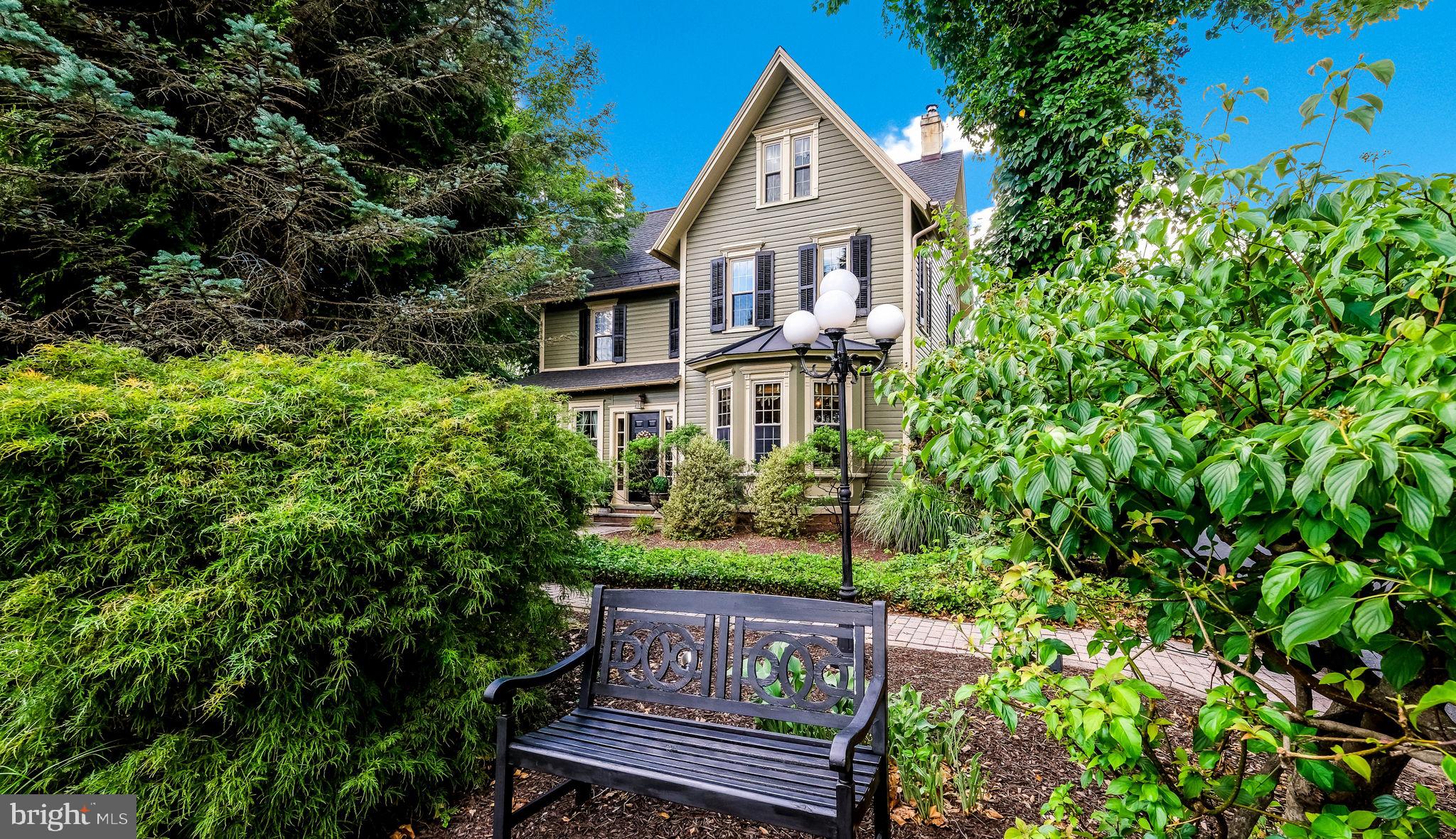 Welcome to 45 E. Butler Ave. New Britain Borough. Step back in time and experience the timeless charm of this beautifully preserved 1885 Victorian home, nestled on a picturesque ¾-acre park-like setting. Surrounded by mature trees, lush landscaping, and open green space, this exceptional property offers a rare blend of historic character, modern conveniences, and peaceful outdoor living.
Inside, you'll find four spacious bedrooms and one-and-a-half bathrooms, showcasing classic Victorian details that reflect the home's rich heritage. Warm and inviting living spaces provide the perfect setting for both everyday living and entertaining, while abundant windows fill the home with natural light and offer beautiful views of the surrounding grounds. The welcoming family room features custom built-ins and a cozy propane stove, creating a comfortable gathering space for family and friends.
The backyard is truly a private retreat, offering a picturesque, park-like setting with plenty of room for recreation and entertaining. Enjoy evenings around the fire pit, unwind in the relaxation tent, and take in the soothing sounds of the water fountain. Mature landscaping enhances the property's natural beauty, while a charming potting shed and impressive carriage house barn provide endless possibilities for gardening, hobbies, storage, workshops, or additional workspace. The barn includes a two-car garage, electric service, a workbench, and abundant storage.
Additional features include a finished attic with plans in place for a future full bathroom, offering excellent potential for expanded living space. The painted basement includes water-sealing concrete and convenient laundry facilities, providing a clean, well-maintained area with added protection and functionality. A whole-house generator offers year-round peace of mind, while the fully fenced backyard with a six-foot fence creates a secluded setting for relaxation, entertaining, and play.
Numerous updates enhance the home's appeal and value, including newer roofs on both the house and barn, new gutters, new windows, Central Air, and freshly painted exteriors on both buildings, making this property truly move-in ready.
Residents will appreciate the low taxes and exceptional location. Enjoy a short walk to the New Britain Train Station, sidewalks throughout the neighborhood, and convenient access to the Doylestown Bike & Hike Trail. Outdoor enthusiasts will love being within walking distance of Covered Bridge Park, offering scenic walking, biking, and running trails, while Peace Valley Park is just a short drive away, providing even more opportunities for recreation and enjoying nature.
Located within the highly regarded Central Bucks School District, this property also offers unique flexibility with its current R-1 Village Historic Commercial zoning designation. As presently zoned, the property may provide opportunities for a home-based business and exterior signage, making it an attractive option for those seeking both residential comfort and potential business use. Buyers are encouraged to verify permitted uses and zoning regulations with the local municipality.
This one-of-a-kind Victorian combines historic elegance, modern updates, versatile outbuildings, and an outstanding location to create a truly special place to call home. More Photos of the Wonderful home to be added Friday afternoon 6/19. Showings start 6/26. Schedule your showing today.