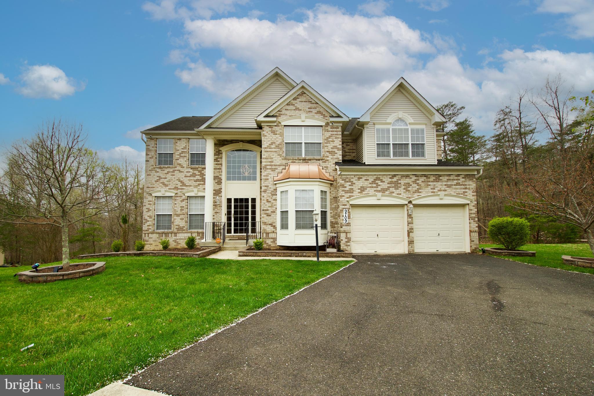 Your gorgeous home awaits your arrival!   As you enter your home, you are welcomed with beautiful hardwood flooring, double crown molding and chair railings that offer the feel of luxury in the foyer, dining room and living room.  This stately property offers additional square footage with its 4th extension in the family room.  The family room is equipped with a stone fireplace and wood blinds, the makings of a cozy relaxing retreat or main level entertainment.  The gourmet kitchen is appointed with stainless steel appliances and granite counter tops.  You have 2 options to access the upper level of the home using the dual access stairs.  Enjoy your spacious master suite that includes a sitting room, double sided fireplace and walk-in closet space.  For your convenience the laundry room is located on the upper level.  The lower level basement is finished with a built-in bar, the 5th bedroom and a full bath to support endless entertaining.  The home is supported by 2 HVAC systems, an in-ground irrigation system with 8 zones covering the front and back outdoor areas, an alarm system (establish your own account) and a deck (2020) overlooking the spacious backyard.