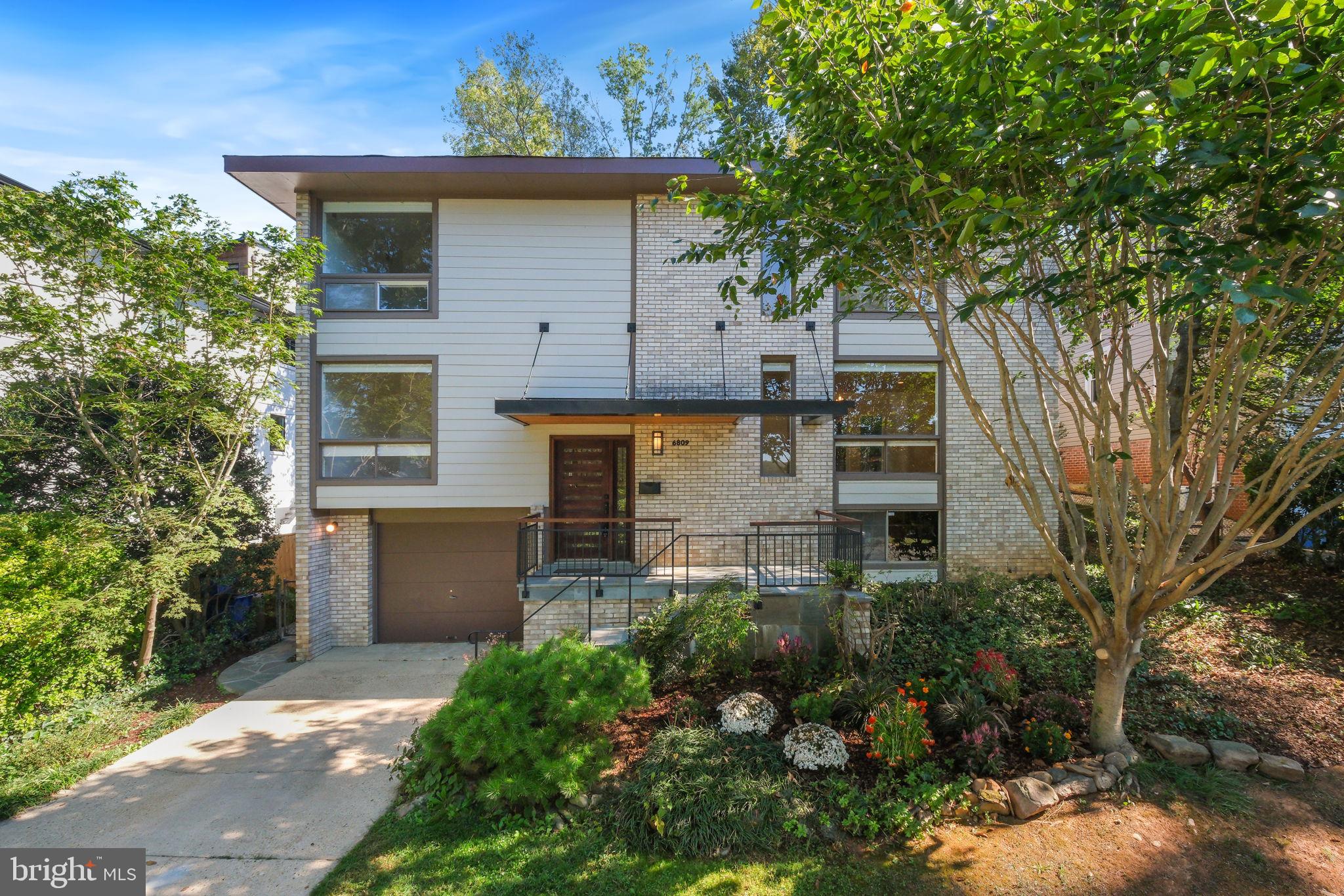 Tucked into a private, tree-lined setting, this custom-built contemporary dazzles with light, volume, and serenity. Vaulted ceilings and expansive windows frame leafy vistas—including owner’s-suite views toward the Virginia hills while a seamless indoor/outdoor flow leads to a covered deck overlooking stone and flower gardens. Thoughtfully renovated throughout, the home features an all-new chef’s kitchen, spa-caliber baths, refreshed exterior, and a fenced rear yard. Flexible living abounds with 5 bedrooms / 3 baths, a private lower-level au pair/guest efficiency, and everyday conveniences like a driveway plus 1-car garage. 
Moments to Glen Echo Park and the C&O Canal & Towpath, offering miles of riverside hiking and biking trails. At the park, ride the historic 1921 Dentzel Carousel, catch children’s theatre at Adventure Theatre MTC, enjoy shows at The Puppet Co., take art classes, and dance nights in the Spanish Ballroom, with festivals year-round. It’s an amenity set that feels more like a lifestyle.
