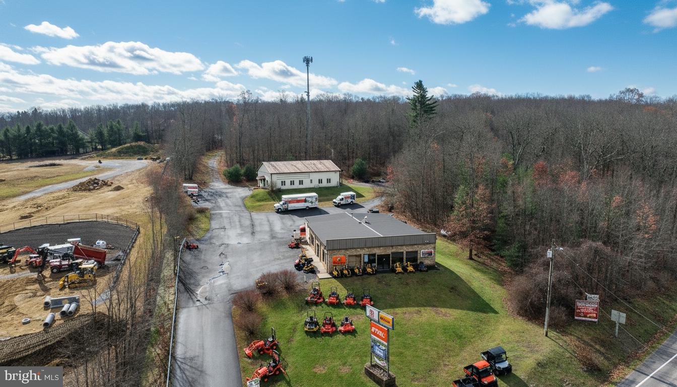 Prime Commercial Location at Deep Creek Lake! A rare opportunity positioned at the high-visibility corner of Rt. 219 & Glendale Road—one of the most traveled intersections in the Deep Creek Lake market. This property features two commercial buildings, 81'x50' & 64'x50'  both currently leased  providing immediate rental income and stability. Additional income from Cellular Tower Lease and Billboard.  Situated on 6.6 acres zoned TC – Town Center, the site allows for a wide array of approved commercial uses including restaurant, motel/hotel, convenience store/gas station, retail, and more. With valuable State Highway access, this location delivers exceptional visibility, traffic flow, and commercial potential. Ample acreage allows for future expansion or redevelopment, making this an ideal investment for both current income and long-term growth.
Excellent commercial exposure and endless possibilities at Deep Creek Lake’s core business hub!