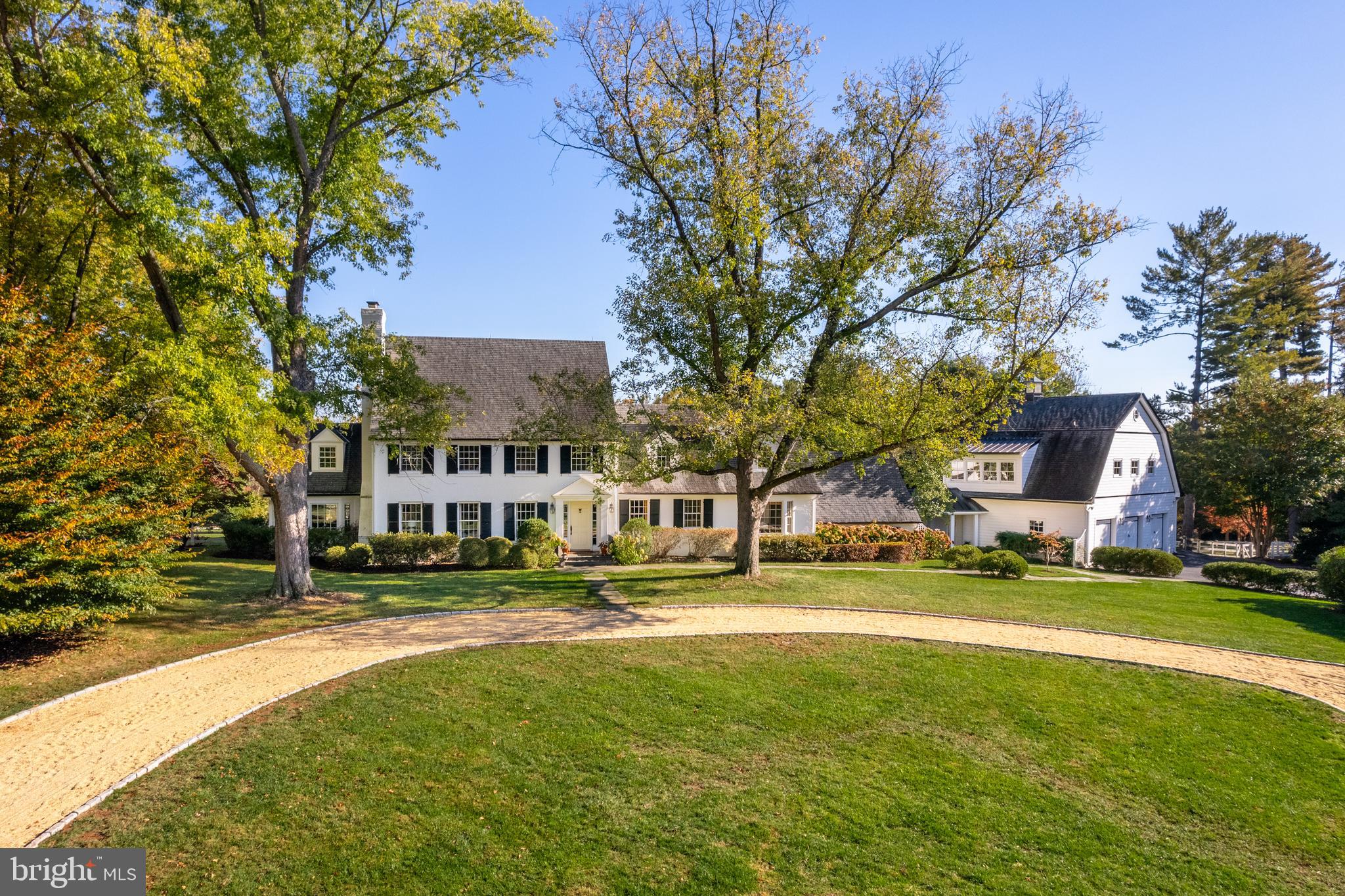 Comprised of two expansive and lush parcels totaling 13.23 acres, 12815 - 12801 River Road is a breathtaking country estate reminiscent of New York’s Adirondacks or the summer residences of The Hamptons. Aptly named as Red Fox Hill, this sprawling manor offers blissful luxury living in a tranquil yet conveniently accessible setting. Solace and serenity abound the manicured grounds, mature trees and rolling hills that encompass the estate, making the property a beautiful respite just outside our nation’s capital. Boasting approximately 10 ,950 total square feet across 4 levels, the Primary Residence and Carriage Home showcase a combined 6 Bedrooms and 5.5 Bathrooms. Delightful design notes extend throughout the primary residence’s interiors to include gleaming hardwood flooring, magnificent millwork, stunningly coffered and vaulted ceilings, beautiful built -ins, and walls of windows that flood the principal living spaces with natural light. Modern fixtures and amenities elegantly complement the home’s traditional yet timeless architectural accent s to offer ease and comfort to today’s style of living.

Although traditionally appointed, the Main Level floor plan provides a seamless flow between formal entertaining spaces and the more relaxed living spaces. The principal living spaces are located on the Main Level and include the formal Dining and Living Rooms flanking the entry foyer, a more informal Gallery and Study, an exquisite Sunroom, and the sprawling Family Room that opens to both the enviable Screened Porch and the rear Terrace. The expansive Gourmet Kitchen is fit for any caliber chef with a large Island, high-end stainless-steel appliances, ample storage space and a wall of windows overlooking the enviable Terrace and lush grounds beyond. A Breakfast Nook with banquette sit s adjacent to the Gourmet Kitchen, providing a more informal dining alternative. Adjacent to the Chef’s Kitchen, French doors open to the rear dining Terrace for idyllic al fresco dining and entertaining overlooking the property’s lush grounds. The Mudroom provides ample storage space and offers breezeway access to the Oversized 5-Car “Car Barn” and Carriage House’s guest quarters that is complete with a fully equipped Kitchen, full Bathroom, and additional storage. The Carriage Home offers incredible views of the property’s enviable 40’ Swimming Pool and Pat io, the perfect respite to relax and enjoy the enchanting landscape that surrounds. An en-suite Bedroom completes the Main Level’s offerings.

The Upper Level showcases 3 of the guest Bedrooms, each offering ample closet space, a hall Bathroom, and the extraordinary Primary Suite. Boasting vaulted ceilings, abundant built-in’s, a cozy fireplace, gleaming hardwoods, and bountiful property views, the Primary Bedroom Suite is complete with an expansive walk-in closet and spa-like Bathroom with dual vanities, clawfoot tub and stall shower. This Suite is truly the ultimate oasis within the residence. The multi-functional Lower Level features a Recreation Room, large Laundry Room with built -ins, and a Full Bathroom. Additional storage space is available on the Top Level. From magnificently appointed and stunningly curated interiors to the jaw-dropping outdoor entertaining spaces and impeccably maintained grounds offering lush gardens and greenery, this Colonial country estate is a one-of-a-kind opportunity that is not to be missed.