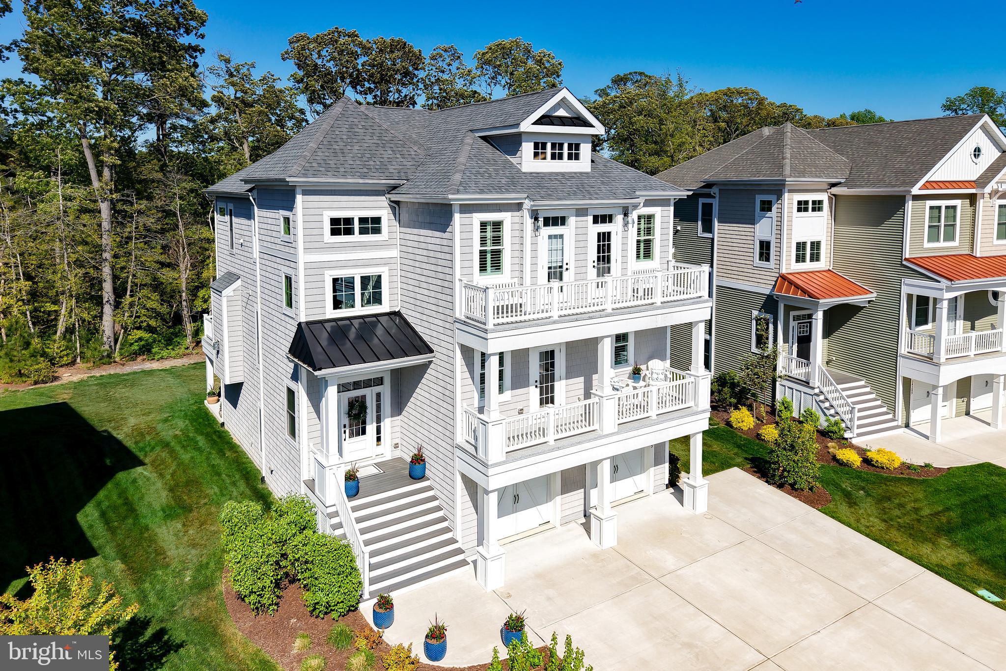 Experience coastal luxury at its finest in this exceptional, expanded Catalina model by Schell Brothers, perfectly positioned in the sought-after waterfront community of Tidewater Landing. Built in 2022, this 5-bedroom, 4.5-bath residence offers a thoughtfully designed floor plan masterfully tailored for both everyday comfort and high-end entertaining. The home’s three levels are seamlessly connected by a private elevator, ensuring effortless accessibility and convenience throughout. From the custom closet systems to the designer finishes and motorized blinds, plantation shutters, every detail has been curated to blend sophistication with functionality.  The heart of the home is the expansive open-concept main level. Here, a gourmet kitchen and dedicated dining area flow into a light-filled great room, all framed by peaceful views toward Love Creek. This level is designed for versatility, featuring a private guest suite with an attached bath, front balcony access, and a conveniently located powder room. The living space extends outdoors to a screened porch and deck, providing the perfect setting for relaxing coastal evenings.  The top floor serves as a dedicated residential retreat. The primary suite is a true sanctuary, boasting a spacious sitting area, dual walk-in closets, a spa-inspired bath, and direct access to a private upper-level deck overlooking the natural surroundings. Two additional generously sized bedrooms both with upper balcony access, a full bath, along with a conveniently located laundry room complete this level. The lower floor adds further depth to the home with a fifth bedroom, a full bath, and a large recreation room equipped with surround sound, ideal for movie nights or a home gym.  Outside, the large backyard provides a rare opportunity to create a private oasis with ample room for a future pool or outdoor kitchen backing to Love Creek, with Crabbing and Fishing in your own back yard!    The driveway is also expanded size for extra parking.  Located just moments from the community pier and kayak launch, this home delivers direct access to the water-centric lifestyle Tidewater Landing is known for. Situated perfectly between Lewes and Rehoboth Beach, you are steps away from world-class dining, shopping, and pristine Atlantic and Delaware Bay beaches.