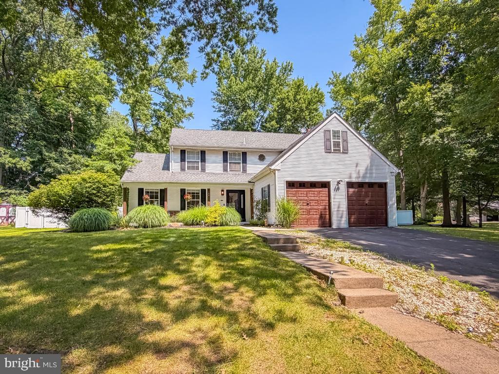 Welcome to this lovely 4 bedroom, 2.1 bath Colonial offering an inviting floor plan designed for both everyday living and entertaining. A welcoming foyer with a turned staircase creates a warm first impression and opens to the living room filled with natural light. The formal dining room provides an elegant setting for holiday gatherings and dinner parties. The updated kitchen is the heart of the home, showcasing white cabinetry, granite countertops, stainless steel appliances, abundant cabinetry, generous counter space, and a spacious breakfast area overlooking the backyard. Just off the kitchen, the inviting family room features a striking brick fireplace, custom built-in cabinetry, and sliding glass doors leading to the patio, creating a seamless transition to outdoor entertaining. An updated powder room and a convenient first-floor laundry room complete the main level. Upstairs, the primary suite offers a walk-in closet and a private en suite bath with a double vanity, stall shower and soaking tub. Three additional generously sized bedrooms share a hall bath. The full basement provides exceptional storage and endless possibilities for future finished living space and is enhanced by a professionally installed WaterGuard basement waterproofing system, providing added peace of mind. Outside, enjoy the fenced backyard with a deck, mature landscaping, and plenty of room for relaxing or entertaining. Completing the home is an attached two-car garage and driveway. This exceptional home offers the space and setting today's buyers have been searching for.