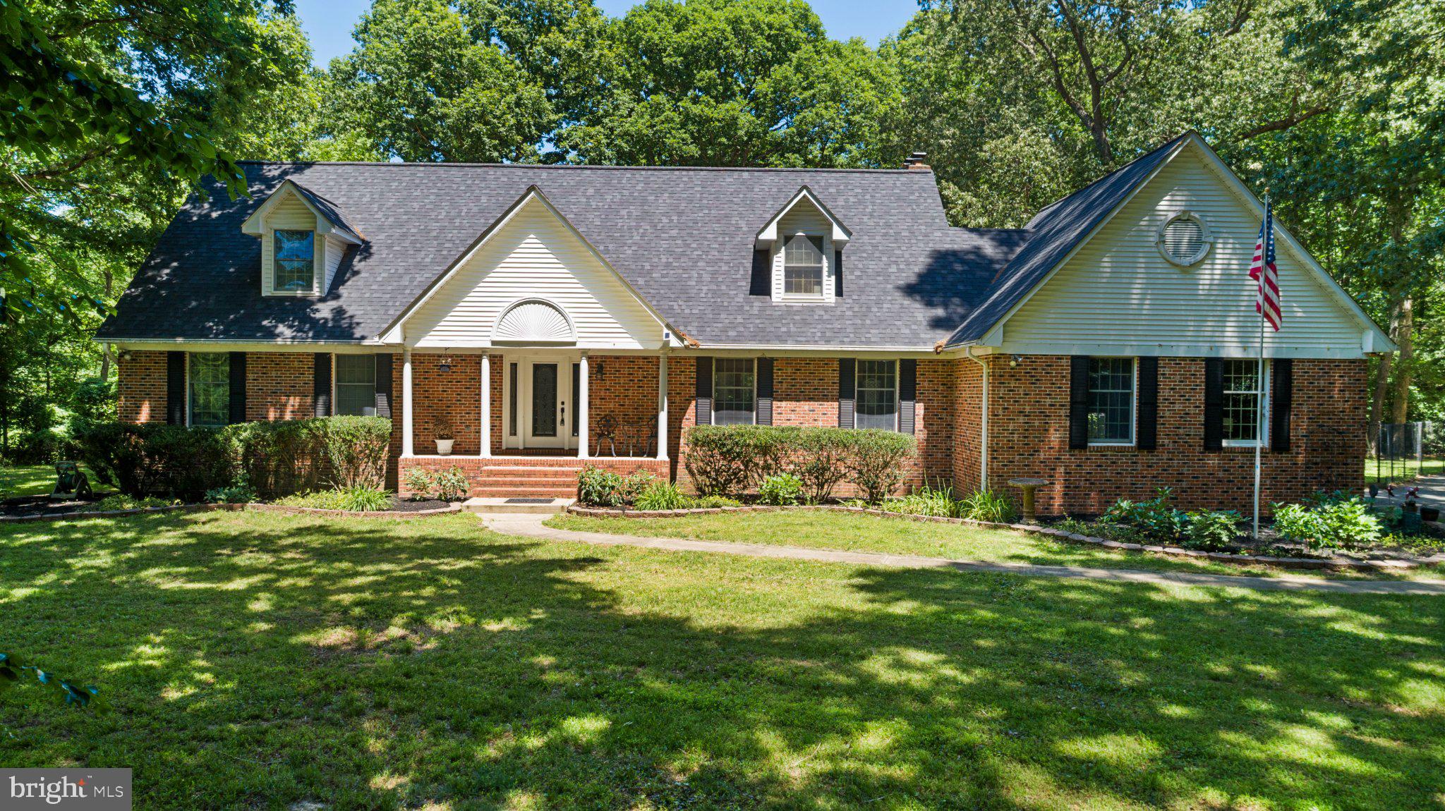 NO HOA! Private 5.25-acre Cape Cod on Pasture Place with ﻿Serene park-like surroundings, open yard space for horse, goats, chickens, and a creek tucked along the wooded edges of the property. Property equipped with a fenced in kid/dog area. This custom home offers incredible garage space with a 2-car attached garage plus a HEATED and COOLED Detached garage with 2 LARGE FRONT BAYS AND 1 side Bay, perfect for a designated workshop, BOAT or RV storage. Inside, you’re welcomed by wood cathedral ceilings and an open-concept kitchen with granite countertops overlooking the living room and formal dining area. The living room features a stunning stone fireplace, wall-to-wall windows, and doors leading to the back deck and peaceful backyard views. The main-level primary bedroom includes a walk-in closet, private bath, and sliders to the back deck. A second bedroom is also located on the main level with adjoining full bathroom that connects to the main level foyer. Upstairs includes two more bedrooms. One of the upstairs bedrooms can be considered another Primary Suite as it has its own full bathroom and bonus room attached. The basement with every brick hand painted is already set up for pool, darts, gaming, bar area, workout space, and a semi-finished half bath. Great future potential for an in-law suite, teen suite, or entertainment area with the walk-up stairs to the outside. Pasture Place features a Bonus detached garage including a bonus area upstairs, perfect for storage or future finished space. Pellet stoves fireplaces on main level and basement level. Located just 30 miles to Patuxent River Naval Base, 31 miles to Joint Base Andrews, and 42 miles to the Naval Academy in Annapolis. Close to parks, boat launch, fishing pier, shops, grocery stores, restaurants, and only 3 miles to a local vineyard. **NEW ROOF MAY 2024** yearly service agreement on boiler, Hot water, heater, Main floor AC, Upstairs AC