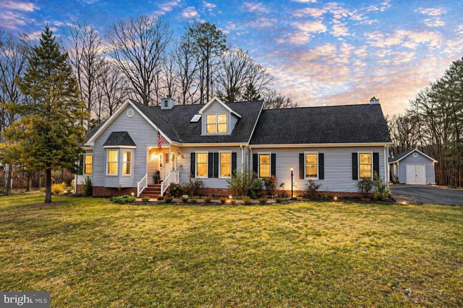 Welcome to this beautiful water view home nestled in a desirable lake community. This 11-room, custom cape cod offers comfort, charm and plenty of space both inside and out.  Situated on a large corner lot the property welcomes you with a brick walkway leading from the wide asphalt driveway to both front and back entrances, setting the tone for the thoughtful details found throughout the home.

Inside you will find a freshly painted interior (Painted March of 2026) complimented by custom hardwood flooring throughout most of main level.  The spacious living areas (living room, dining room and family room) are perfect for relaxing or entertaining and feature a family room with wood burning fireplace, recessed lighting, built-in cabinet and easy access to outdoor living spaces.  The kitchen has been continually updated and has granite countertops, undermount sink, flat-top stove, double ovens, new refrigerator and microwave, and recessed lighting which creates a functional and stylish cooking space.

The main level of the home offers the convenience of one level living by having a primary bedroom suite.  Upstairs you will find five rooms, one of which is a large bonus room over the garage and is ideal for recreation space or home office, and a full bath.
Outdoor living is just as impressive with a large screened porch featuring two skylights and is connected on the left by a large deck and on the right by a patio and a small koi pond. The backyard also contains a small basketball court next to the shed, which matches the home.

Additional highlights include a huge two-car garage with a mop sink, a large laundry room with cabinets, counter space, built in desk, and a new washer and dryer (2026).  There is generous closet and storage space throughout the home and additional attic storage.  The home has been well-maintained, including major systems.  The roof was replaced in 2014, and dual-zone complete HVAC systems were installed in 2016 (March 2026 inspection report for HVAC systems available).

Residents enjoy an exceptional array of neighborhood amenities designed to support an active and engaging lifestyle. Community features include swimming pools, a fully equipped fitness center, basketball courts, tennis and pickleball courts, private boating docks, community beaches, and designated fishing areas. Additional amenities include multiple clubhouses, covered pavilions, a shooting range, archery range, and 24-hour security for added peace of mind. This amenity-rich community offers something for everyone.