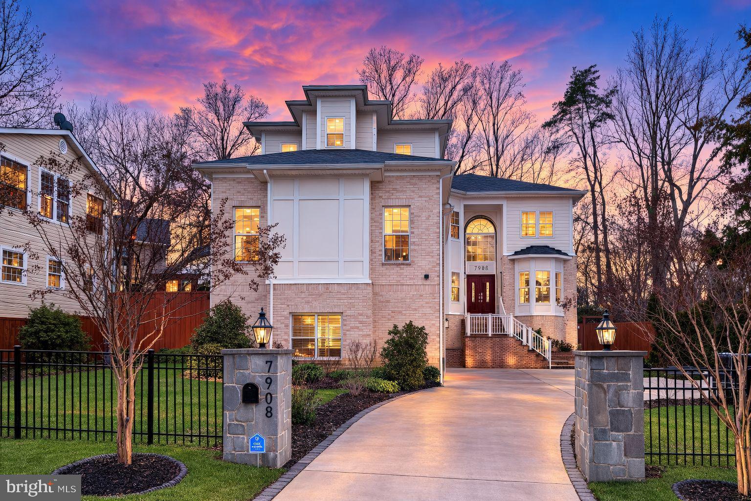 Introducing 7908 Holmes Run Dr, a striking custom built estate residence offering nearly 7,900 square feet of modern luxury inside the Beltway. Built in 2021 and thoughtfully arranged across three expansive levels, this exceptional home features 6 bedrooms, 6.5 bathrooms, and a rare 3-car garage, delivering the scale of a luxury estate with the everyday convenience of Falls Church living.  From the moment you step inside, the home establishes a sense of arrival and intention.  A dramatic foyer unfolds into sunlit living spaces where soaring ceilings, oversized windows, and rich hardwood flooring create a seamless sense of flow throughout the main level.  Each room feels both grand in proportion and effortlessly comfortable for daily living.  At the center of the home, the chef’s kitchen anchors the main level with both presence and performance. Quartz countertops, custom cabinetry, premium appliances, and an oversized island create a natural gathering place, equally suited for casual mornings, weeknight dinners, and lively entertaining.  A secondary full kitchen on the main level adds an uncommon level of flexibility, ideal for large gatherings, catering support, or multi-generational living.  Upstairs, the primary suite offers a private retreat designed for comfort and restoration. Generous in size and thoughtfully finished, the suite is complemented by a spa-inspired bathroom that brings a sense of calm to everyday routines. Each additional bedroom is well proportioned and privately positioned, creating a home where guests and family members enjoy both space and privacy.  The fully finished walkout lower level further expands the home’s possibilities, providing generous room for recreation, entertainment, fitness, or extended guest accommodations. Whether envisioned as a media lounge, home gym, or gathering space, the lower level adds meaningful versatility to the overall design.  Perfectly positioned on a beautifully situated lot, the home is just minutes from the vibrant restaurants, shopping, and entertainment of the Mosaic District while offering convenient access to the Capital Beltway and major commuter routes.  The location balances accessibility with the quiet character of an established residential neighborhood. Opportunities to own a recently built home of this scale inside the Beltway are increasingly rare.  With nearly 8,000 square feet of thoughtfully designed living space, modern construction, and an exceptional location, 7908 Holmes Run Dr represents one of the most compelling luxury offerings currently available in the area.  Imagine quiet mornings overlooking the surrounding greenery, evenings gathered around the kitchen island with friends and family, and weekends hosting in spaces designed to bring people together.  Every element of this home was created to support a lifestyle defined by comfort, elegance, and effortless entertaining.
Exclusive private tours begin soon.  Professional photos will debut Wednesday, March 8.