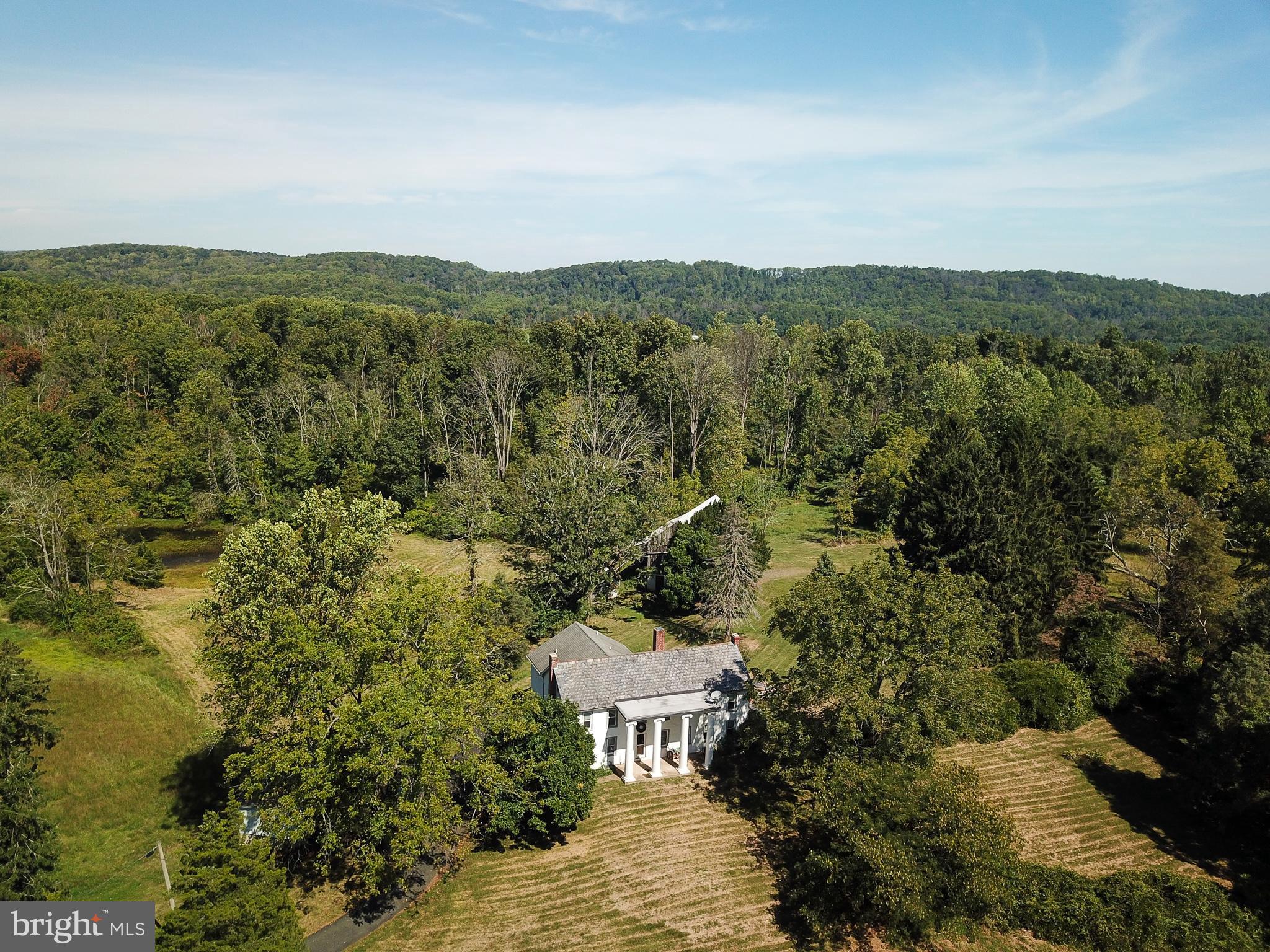 Deep Creek Farm is available for the first time in several generations.  This exceptional property on an impressive 78.11 Acres is a rare find indeed.  Situated in a quiet pocket in New Hanover Township surrounded by other large tracts and low-density zoning, this idyllic gem offers a vast list of possibilities.  Just over 2 hours from Midtown Manhattan and 1 from Philadelphia, it could be the retreat from the madness your inner self has been aching for.  Dream of a life where your hands and hard labor bring you deep satisfaction from the land?  It's here.  Do you have an agricultural opportunity?  The topsoil is deep and fertile and the pastures are well-drained and sunny.  Timber? Check. Pond? A beauty.  Are you a hunter seeking a natural preserve?  Indeed, generations to come can live off this prime land. Have you been seeking the perfect spot that's isolated from all neighbors and prying eyes for your side gig?  At last, you've discovered it.  A true family compound that sustains and shelters all of your loved ones and their families?  Yes.  Perhaps a development opportunity that preserves the impressive residence on 60-plus acres and offers a way to spin off a great deal of cash for your future.  Yes, Deep Creek Farm presents an excellent option for that.  The residence is a perfect blend of a practical colonial and a grand estate with features like a four towering Antebellum Column facade with a surprising historical tale. How about a lavish 500 square foot master bedroom with a soaring ceiling?  There is a modern and stylish kitchen in the heart of the living space, and a huge living room with beamed ceilings and an immense stone fireplace.  Recent additions with den and solarium space, a walkout basement and of course a 40X20 Anttique timber framed barn for all the treasures in your life.   If this sounds like something that is worthy of your time to investigate, your hunch is correct.  This opportunity to live very differently is increasingly rare.  In the literally 3.4 million square feet of paradise that is Deep Creek Farm, you will find your peace and revel in your great find.