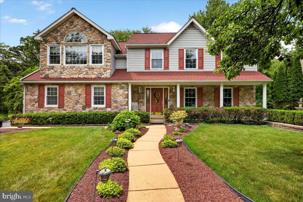 Welcome to this beautiful traditional home in the highly sought-after Doylestown Hunt community. Ideally situated on a private cul-de-sac in desirable Doylestown Township within the award-winning Central Bucks School District, this exceptional property is just a short walk from the heart of downtown and offers the perfect combination of privacy, space, and convenience.
A charming front porch welcomes you inside to a spacious foyer. To the right, the formal dining room features beautiful hardwood floors, abundant natural light, and ample space for hosting holiday gatherings. Adjacent to the dining room is a versatile living room, currently used as a home office with custom built-in shelving, that can easily serve as a formal living room or additional entertaining space.
The spacious kitchen is truly the heart of the home, featuring double ovens, abundant cabinetry and counter space, and two large islands with seating. The kitchen flows seamlessly into the impressive two-story family room, part of a thoughtfully designed addition completed in 2003. A stunning floor-to-ceiling stone fireplace serves as the centerpiece of the room, while the adjoining wet bar with seating for up to six creates the perfect space for entertaining. Whether hosting game day, movie nights, or large gatherings, this room offers exceptional flexibility. A convenient beverage center between the kitchen and family room is ideal for your morning coffee.
Completing the first floor are a spacious powder room, a large laundry/mud room, and a versatile workshop and hobby space created from the converted garage. This flexible area could also serve as a home office, studio, or business workspace.
Upstairs, the expansive primary suite, also added in 2003, offers a private retreat complete with generous closet space and a cozy reading nook overlooking the family room below. The luxurious primary bath features abundant natural light, a large walk-in shower, and a relaxing soaking tub. Three additional bedrooms complete the second floor, including a spacious ensuite bedroom with its own private bath that previously served as the home's primary bedroom. This private suite offers two closets and is ideal for guests, older children, multigenerational living, or anyone seeking additional privacy. A full hall bath serves the remaining two generously sized bedrooms.
The finished basement provides even more living space with areas for recreation, fitness, work, or hobbies, along with the added luxury of a sauna that is included with the home. An unfinished storage area offers abundant space for seasonal items and organization.
Step outside to your private outdoor oasis, thoughtfully designed for both relaxation and entertaining. The backyard features a patio for outdoor dining, a separate seating area surrounded by a beautiful stone wall, a fire pit gathering area, and a storage shed. Nestled at the back of the neighborhood, the property backs to wooded township land and borders additional township-owned open space, creating an exceptionally private setting with peaceful, scenic views.
Ideally located just minutes from the heart of downtown Doylestown, you'll enjoy easy access to the farmers market, boutique shopping, award-winning restaurants, museums, and the SEPTA train station for convenient travel to Philadelphia. The home's central Bucks County location also places Peddler's Village, New Hope, NYC, the Jersey Shore, and the Pocono Mountains within easy reach for day trips and weekend getaways.
Offering an exceptional combination of privacy, generous living space, and an unbeatable location, this remarkable home is ready to welcome its next owners. Don't miss the opportunity to make it yours!
Please Note: The home was expanded with an approximately 1,600 SF addition in 2003, enhancing the living space with the impressive two-story family room and expansive primary suite.