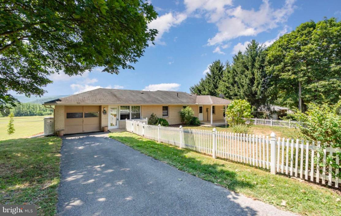 Looking for One Level Living, in a Country Setting, with a Dramatic, Panoramic, Scenic View from your Wide Living Room Windows?   Ready to Move In Right Away?  This may be the Home for You!  This Mid-Century Modern Ranch Home Features 2 Bedrooms, 1.5 Baths, 4-Season Sunroom,  Open Floor Plan, 1 Car Garage, Fenced Yard, Updated Kitchen, all on a Spacious, nearly Half-acre Lot.  The Home needs some minor Cosmetic work, but you can Move In on Settlement Day!  It is located in an Alley, along with other similar Homes around it.  Other Features include:  Hardwood Floors, Economical Pellet Stove and Radiant Electric Heat, New 200 AMP Electric Panel and Well Pump, Exterior Shed and a Swing to Enjoy the View!  See This Home Today and Make Your Country Living Dream a Reality!