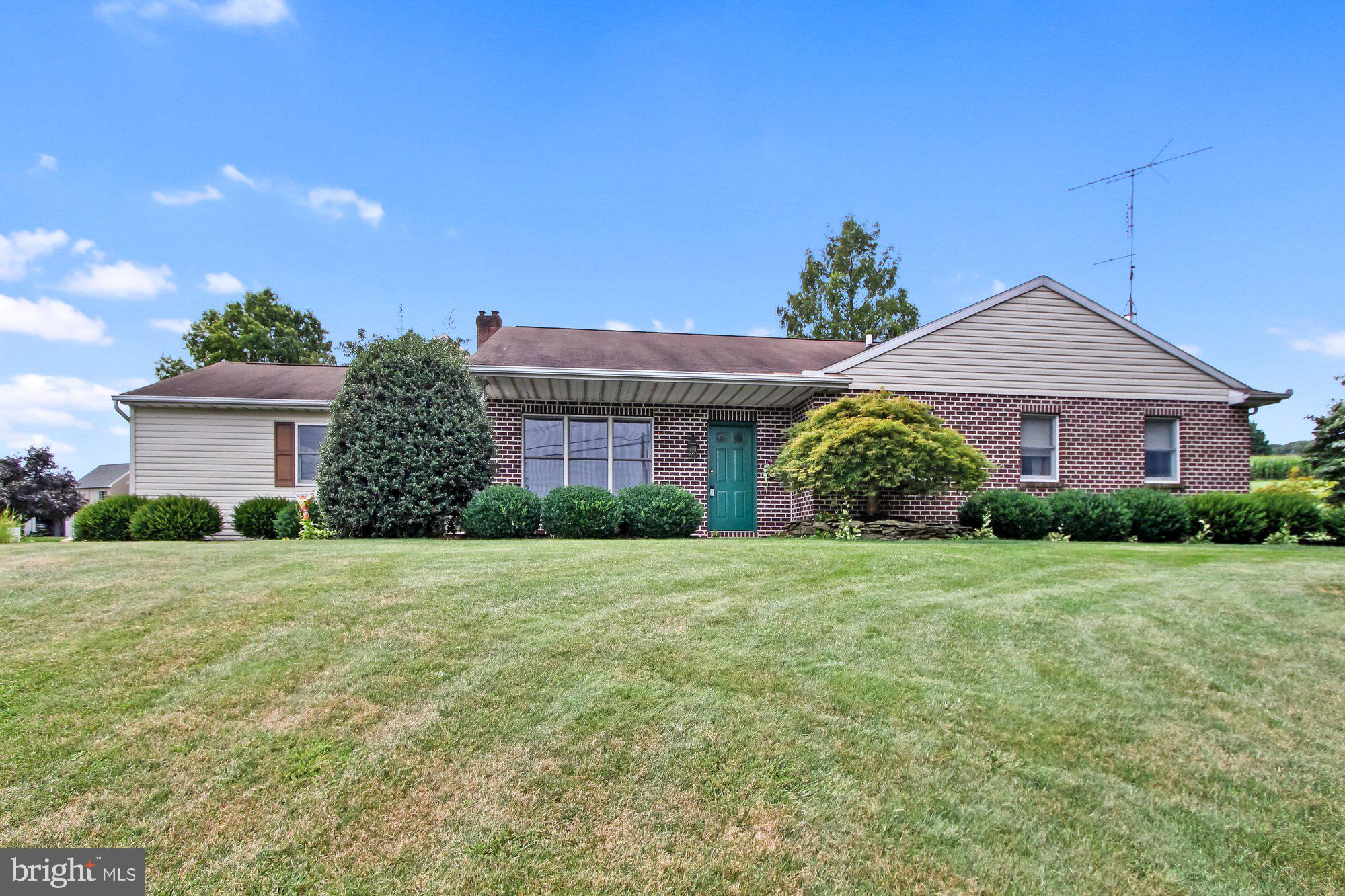 A little bit of a country feel comes with this delightful 3BR, 2BA rancher! Relax on the covered front porch and watch as the cars pass by or unwind on the 2-tiered rear deck and enjoy the beauty of the lot. Inside you will find a flexible floor plan offering a living room, eat-in kitchen open to a dining area or use as the current owners do, a family room. The room features a gas fireplace. The beautiful kitchen showcases ceramic tile flooring, granite counters, and a large island with overhang for seating 4+ barstools. Curl up with a good book in the vaulted ceiling 4-seasons room full of natural light. A slider leads to the rear deck. The primary bedroom has a full bath and walk-in closet. The laundry room is conveniently located on the 1st floor, just off the kitchen. In the event you need additional living space, the lower level is available for expanding. One 12x19 room is already finished for whatever space you might need.  Oversized, end-load, finished 2-car garage with laundry tub, attic access and garage door opener. An additional service garage is located on the other side  of the home and is the perfect spot to store patio furniture and mowing/gardening items.  Indian Springs is located in Red Lion Schools and is minutes to a world of conveniences including shopping, food, schools, parks, I83 and Rt30.  AGENTS - Please read Agent Remarks!