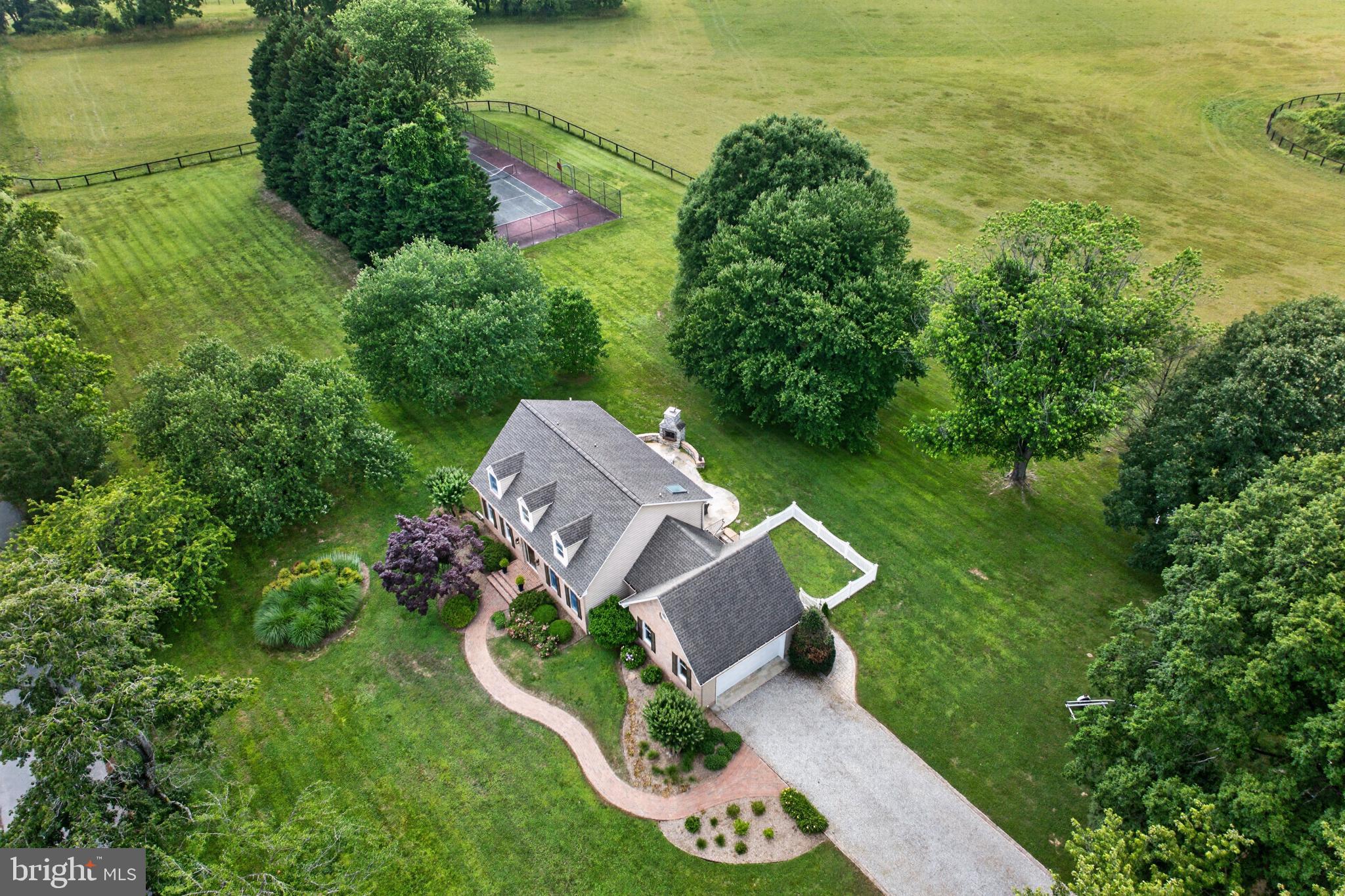 A rare opportunity to own over 2 private acres in one of Annapolis’ most desirable waterfront communities. Complete with a private tennis court and backing to a sprawling horse farm, this exceptional property offers the perfect blend of privacy, recreation, and the Chesapeake lifestyle. Nestled in the sought-after Whitehall Beach neighborhood, residents enjoy community water access, a fishing pier, and the relaxed coastal lifestyle this special enclave is known for. Lovingly maintained by the same owners for many years, this custom home has been exceptionally cared for and thoughtfully preserved. Offering the best of both worlds, it combines tranquil country living with the convenience of being just minutes from downtown Annapolis, waterfront dining, marinas, Route 50, and the highly regarded Broadneck school district. Inside, you’ll find a warm and inviting floor plan with high ceilings, abundant natural light, and timeless custom built-ins that create an inviting main living area. The spacious unfinished lower level provides endless possibilities for future living space, a home gym, workshop, or additional storage. The expansive grounds offer plenty of room to entertain, garden, or simply enjoy your own private retreat, with potential space for a future pool or additional outdoor amenities, subject to buyer verification and all applicable approvals - making this an exceptional offering where privacy, community, and the Chesapeake lifestyle come together. Schedule your private tour today!