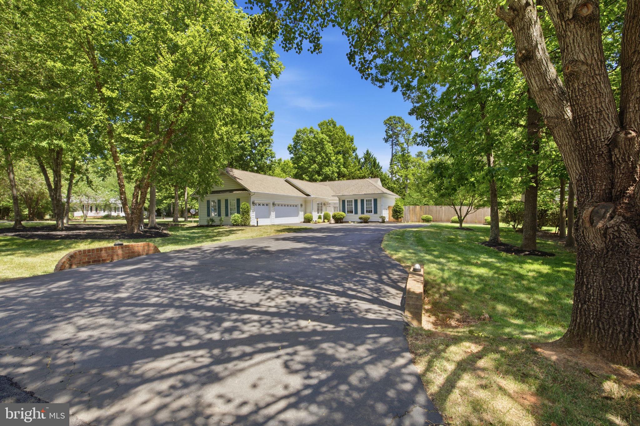 Welcome to 11709 Cedar Creek Court, an exceptional opportunity to own a beautifully maintained home in the prestigious gated community of Fawn Lake. Offering desirable main-level living, a private saltwater pool, and a separate guest cottage, this home delivers the perfect blend of comfort, elegance, and resort-style living.

Step inside to discover gorgeous hardwood flooring, a light-filled family room, and a spacious sunroom that also makes an ideal home office. The updated kitchen is a chef's delight, featuring quartz countertops, a tiled backsplash, beautiful cabinetry, stainless steel appliances installed in 2024, double ovens, and a gas cooktop. Entertain with ease in the formal dining room or gather around the stunning double-sided gas fireplace accented by custom built-ins, crown molding, and elegant architectural details throughout.

The spacious primary suite offers a large walk-in closet and private bath, while the secondary bedroom features a generous closet and fresh paint. Through the private courtyard gate, you'll find a detached guest cottage complete with a full bathroom and third bedroom—perfect for extended family, guests, an au pair, private office, fitness studio, or hobby space.

Outside, enjoy your own backyard retreat featuring a fully fenced yard and sparkling saltwater pool. The pool has been recently inspected, is in excellent condition, and is ready to enjoy all summer long. Recent updates include pool equipment replaced in 2024, a new pool cover in 2025, stainless steel kitchen appliances installed in 2024, a dual-fuel heat pump installed in 2020, a new washer and dryer in 2024, and an owned 500-gallon propane tank. The oversized 3-car garage offers abundant storage, while the pull-down attic provides additional standing-room storage space.

Situated on a private corner lot, this home offers both tranquility and convenience within one of Virginia's premier gated communities. Residents of Fawn Lake enjoy an unmatched lifestyle with access to a private lake featuring sandy beaches, a championship golf course, clubhouse, community pool, tennis and pickleball courts, fitness facilities, marina, walking trails, playgrounds, dog park, on-site dining, and a year-round calendar of social events and activities.

Whether you're relaxing by your private pool, hosting family and friends in the detached guest cottage, enjoying a round of golf, or spending the day on the lake, 11709 Cedar Creek Court offers the opportunity to experience luxury living and resort-style amenities every day.