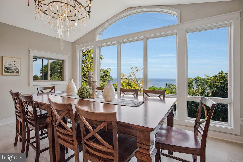 Huge Price Improvement! * Don't miss this opportunity to wake up to INCREDIBLE VIEWS of the CHESAPEAKE BAY in this stunning, custom-built home on 1.3+ ACRES,   thoughtfully designed for comfort, casual elegance, and energy efficiency—with a sought-after FIRST FLOOR PRIMARY BEDROOM SUITE.  Peace and privacy surround you as you watch the SUN RISE over the horizon, boats drift across the water, and the Eastern Shore shimmer in the distance.  FULLY-OWNED SOLAR PANELS with five energy storage batteries ( Tesla PowerWalls)  keep energy costs remarkably low, while the secluded setting—tucked at the end of a quiet road shared by only three other luxury homes—offers serenity and preserved natural beauty. * Inside, the grand foyer showcases gorgeous WALNUT HARDWOOD FLOORS, custom millwork, and an elegant staircase. The OPEN-CONCEPT GREAT ROOM impresses with a soaring coffered ceiling, clerestory windows, and cozy wood stove. * The GOURMET KITCHEN features rich cherry cabinetry, a large ISLAND with seating,  ENORMOUS PANTRY, and PREMIUM APPLIANCES including dual refrigerators, double ovens, and a six-burner gas cooktop. The adjoining dining area captures UNFORGETTABLE BAY VIEWS through a wall of windows rising to the VAULTED CEILING. * Enjoy seamless indoor-outdoor living and entertaining on the SCREENED PORCH with outdoor kitchen setup, all-season SUNROOM, and DECK—all perfect for taking in the views. * The MAIN LEVEL MASTER BEDROOM SUITE is a private retreat with BAY VIEWS,  direct access to the sunroom, a spa-inspired bath, and a large walk-in closet AND a huge DRESSING-ROOM CLOSET! A LUXURY LAUNDRY ROOM,   a HOME OFFICE (or additional bedroom), mudroom, and oversized three-car garage with two EV charging ports complete the main level. * Upstairs offers a LOFT and THREE ADDITIONAL BEDROOMS—ALL WITH BAY VIEWS—plus a beautifully appointed bath. * The LOWER LEVEL adds another bedroom, full bath, THEATER ROOM, wine cellar, and recreation spaces, along with a large semi-finished room ideal for a workshop, gym or studio. * Outdoors, enjoy lush landscaping, a koi pond with waterfall, patio, irrigation system, and large garden shed.  * The ADJACENT 1.18-ACRE BUILDABLE LOT is also available for purchase from these sellers. * Located in Huntingtown with TOP-RATED SCHOOLS and an easy commute to D.C. and Annapolis, this remarkable home blends breathtaking views, refined finishes, and exceptional efficiency—an extraordinary waterfront retreat to call your own.