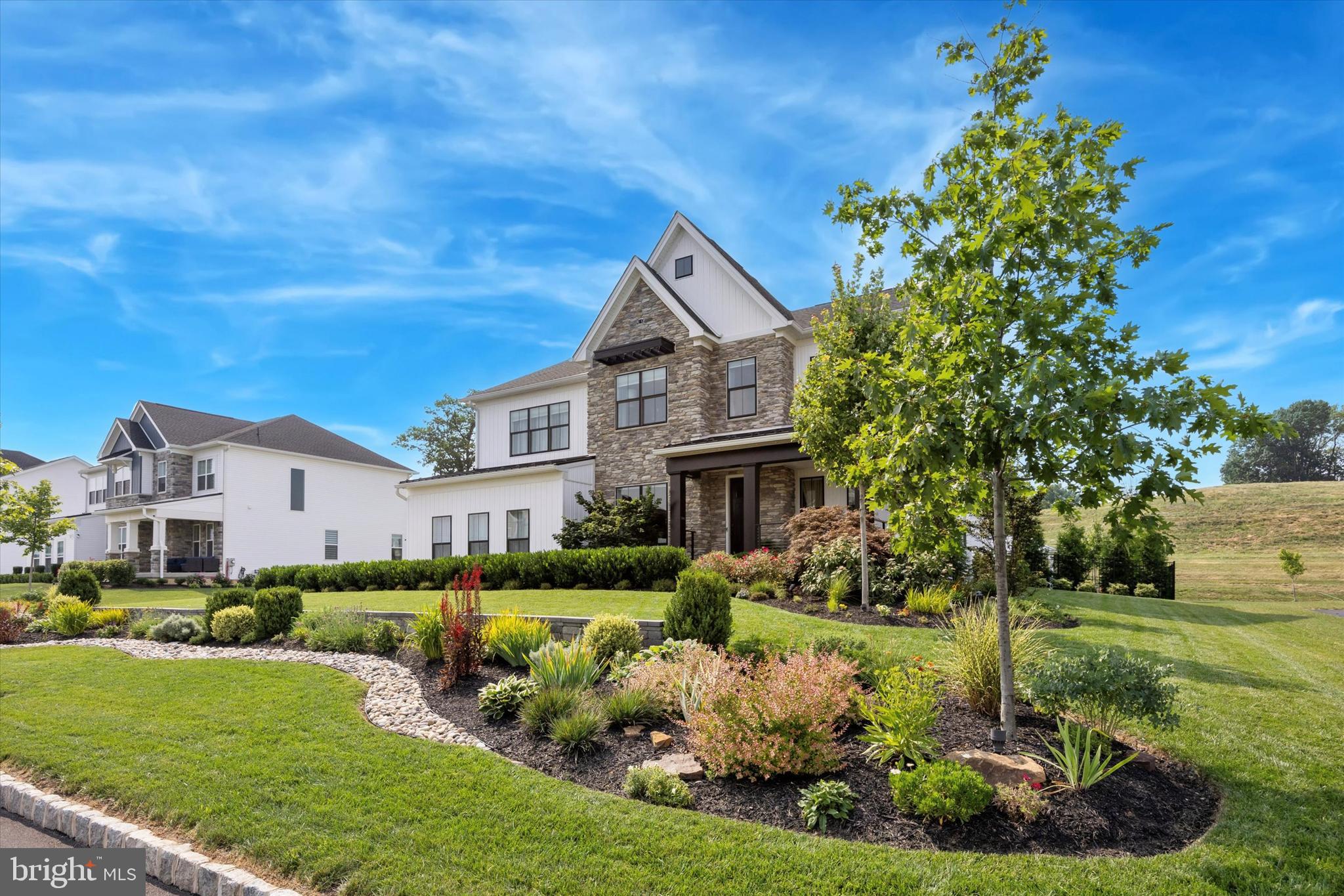Welcome to this exceptional 6-bedroom, 5.5-bath custom home located in the award-winning Methacton School District. Thoughtfully designed from top to bottom, this residence offers a perfect blend of luxury, functionality, and elevated everyday living.
From the moment you arrive, the professionally landscaped grounds and custom hardscaping make a striking first impression. Inside, the bright and open main level is filled with natural light, highlighted by a dramatic picture window and a statement fireplace that anchors the living space. The seamless flow between the living, dining, and kitchen areas creates an ideal setting for both entertaining and daily life. A private den/office, powder room, pantry, and a main-level bedroom with en-suite bath provide flexibility for guests or multi-generational living. The finished 3-car garage is equally impressive, featuring epoxy floors, custom cabinetry, insulated doors, and a polished finish.
Upstairs, a versatile loft offers additional living space. Two bedrooms share a well-appointed Jack-and-Jill bath, while a third bedroom includes its own private bath. A convenient laundry room with a dedicated pet-washing station adds everyday ease. The owner’s suite is a true retreat, showcasing a custom accent wall with a built-in electric fireplace, dual vanities, an oversized tiled shower, and an expansive walk-in closet complete with a center island.
The lower level, accessed through a hidden bookcase door, delivers a unique and unforgettable experience. Fully soundproofed, this space is designed for entertaining with a speakeasy-inspired feel. Enjoy a full wet bar with beverage fridge, icemaker, sink, dishwasher, and a stunning island, along with a 6-foot electric fireplace and multiple lounge areas. A bonus bedroom, full bath, additional storage, and a second laundry area complete this level.
Step outside to your private backyard retreat, designed for year-round enjoyment. The covered patio features remote-controlled, weather-rated screens, ambient lighting, and a beautiful natural gas fireplace. A relaxing spa/hot tub sits just beyond, while the custom pavilion offers a fully equipped outdoor kitchen with sink, refrigerator, gas grill, and wet bar—perfect for entertaining. A full sprinkler system and custom shed add convenience and thoughtful detail.
Ideally located just minutes from Heebner Park, Zacharias Creek Trail, and Skippack Village, this one-of-a-kind home offers an unmatched lifestyle in a prime location.