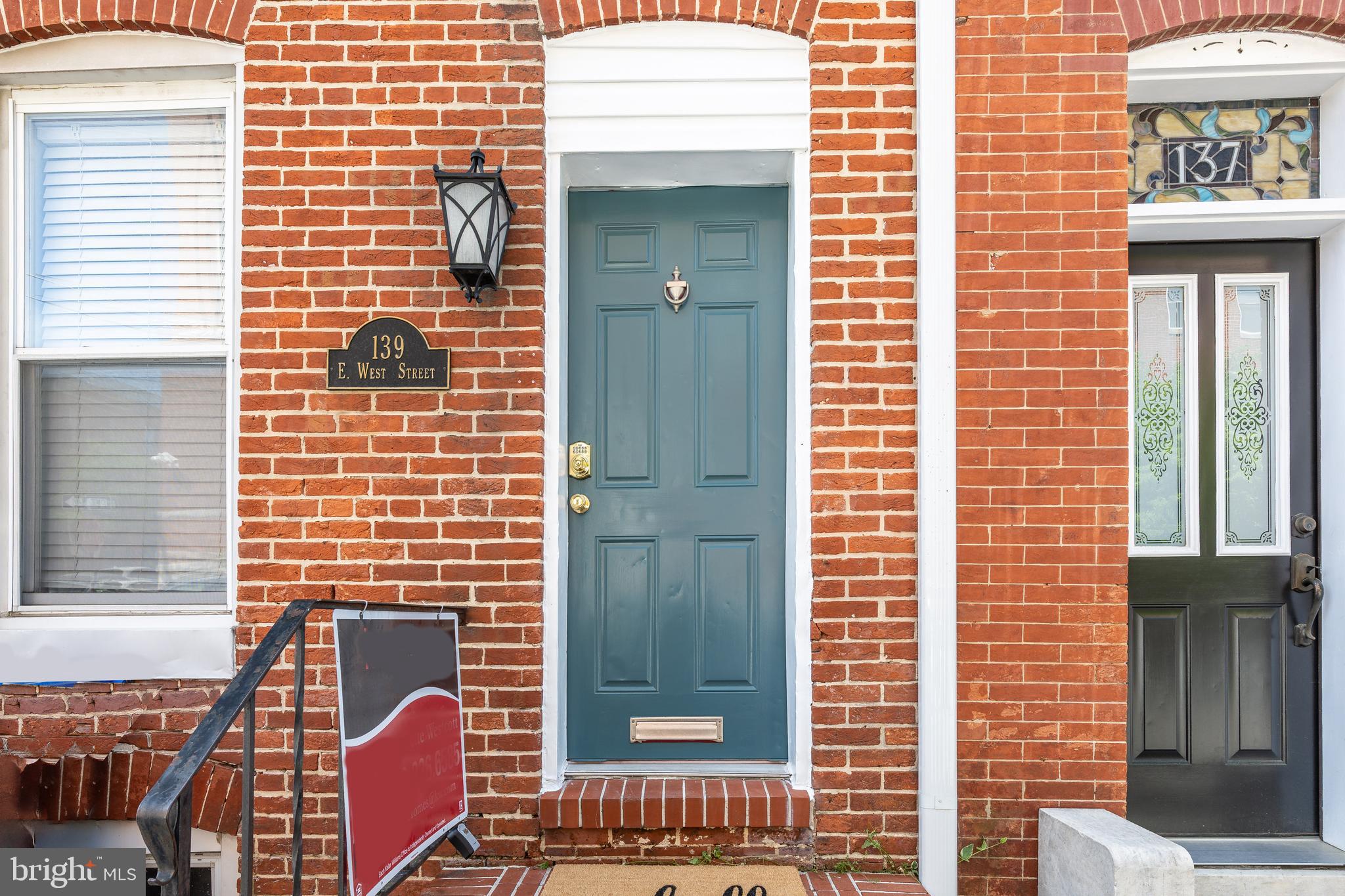 Welcome to 139 E West St, a beautifully refreshed 4 bedroom, 3 bath rowhome in the heart of Federal Hill. This 1,853 sq ft property seamlessly blends historic charm with modern convenience, making it an ideal personal home or perfect  investment opportunity.   As you enter, you'll love the stunning exposed brick walls and hardwood floors that flow throughout.  The living room is quite spacious and if you're looking for a separate dining room or additional seating/living space, the separate dining room  is nothing short of ideal. From the kitchen, which is great for meal prep, there is access to the enclosed side and rear patio area - a perfect outdoor entertaining area for friends and family. A full bath is conveniently located on this level, as well.    On the first level up, you’ll find two spacious bedrooms, both featuring brand-new carpet and fresh paint. This level features a full hall bath and laundry room, as well as a smaller room with a charming en-suite bathroom, fully renovated to offer a private retreat for guests or family. The largest of the full baths is located on this level and you will certainly enjoy the soaking tub for relaxation at the end of a long day.   The third floor features two very spacious additional bedrooms, both of which showcase beautiful hardwood floors, adding warmth and character to the space.      **     All electrical wiring and the mast have been replaced, new roof and siding in 2025, fresh paint and carpet throughout.  The home is equipped with an air purifier in the AC unit for added air quality and a new dryer (installed in 2025). Located just steps from Federal Hill Park, Cross Street Market, and the Inner Harbor, this home offers easy access to I-95, Camden Train Station, and local stadiums, making it perfect for anyone looking to enjoy the best of Baltimore city living.   Whether you’re seeking a vibrant new home or a high-demand rental, 139 E West St provides a prime opportunity in one of the city’s most sought-after neighborhoods. Don’t miss your chance to own this gem!