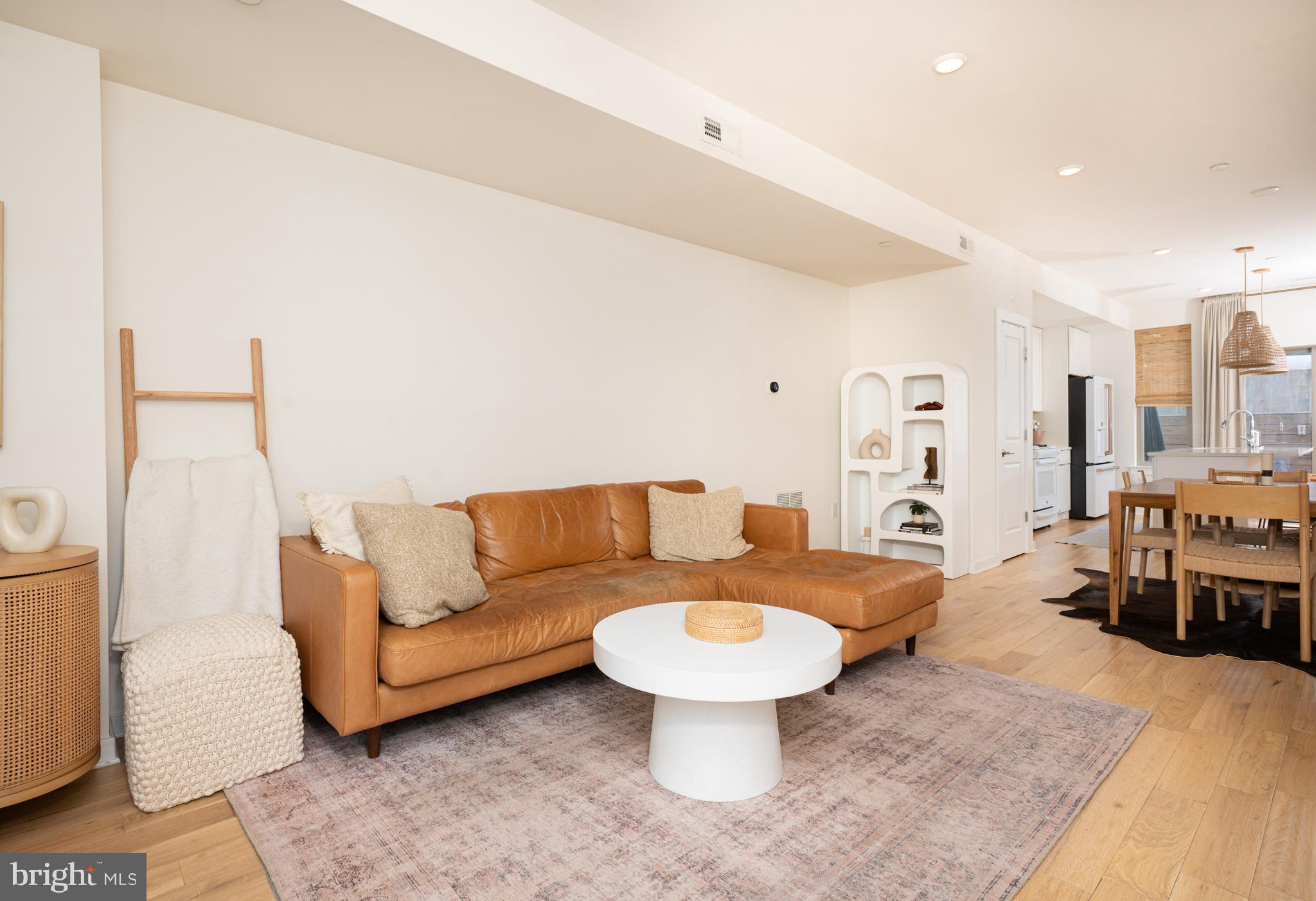 From the moment you pull up to unit B73 inside Kensington Courts and park in the designated parking spot right outside of the home you will immediately notice the peaceful quiet off street location. This 3 year young move - in ready townhouse was custom designed with over $30,000 of upgrades including: wide plank solid white oak flooring throughout, upgraded LVP in the finished basement, custom kitchen backsplash, dimmable lighting, gas fireplace, all upgraded appliances, and even a dedicated 220 amp outlet and structural concrete for a hot tub. Appreciate the warmth of natural light washing over the open and extra wide floor plan with 9 ft. Ceilings. The living room features a gas fireplace and the wide plank, white oak, hardwood floors lead you into the dining space while transitioning into the spacious custom kitchen. The rear slider leads you to a private patio with a wood privacy fence, and direct access to the 1 mile walking trail. Head directly out the backyard and take your dog for a walk down to the private dog park. Heading up the hardwood staircase, we find our two spacious bedrooms (both have room for king sized beds) hall bathroom, stackable laundry, and linen closet.  The primary suite is complemented by an ensuite bathroom that offers a frameless glass stall shower with black matte hardware, Anthropologie mirrored vanities, and complimentary tile floors. Heading down the hardwood staircase is the fully finished basement featuring upgraded Luxury Vinyl Plank flooring, egress window, and an opportunity to reconfigure and add a 3rd bedroom and potentially even a 3rd bathroom. Owners left this open for flex space. Get the best of city living and the perks of being in a development - private parking, private trash pick up, snow removal and shoveling, exterior maintenance, landscaping all while being within walking or biking distance to BOTH trending Fishtown and newly revitalizing Port Richmond. As surrounding redevelopment continues; recreational amenities continue to blossom in the corridor. Minutes from 95, 676, and 76 so you can be anywhere quick! This home also has 7 years left on the tax abatement and 7 years left on the structural warranty.