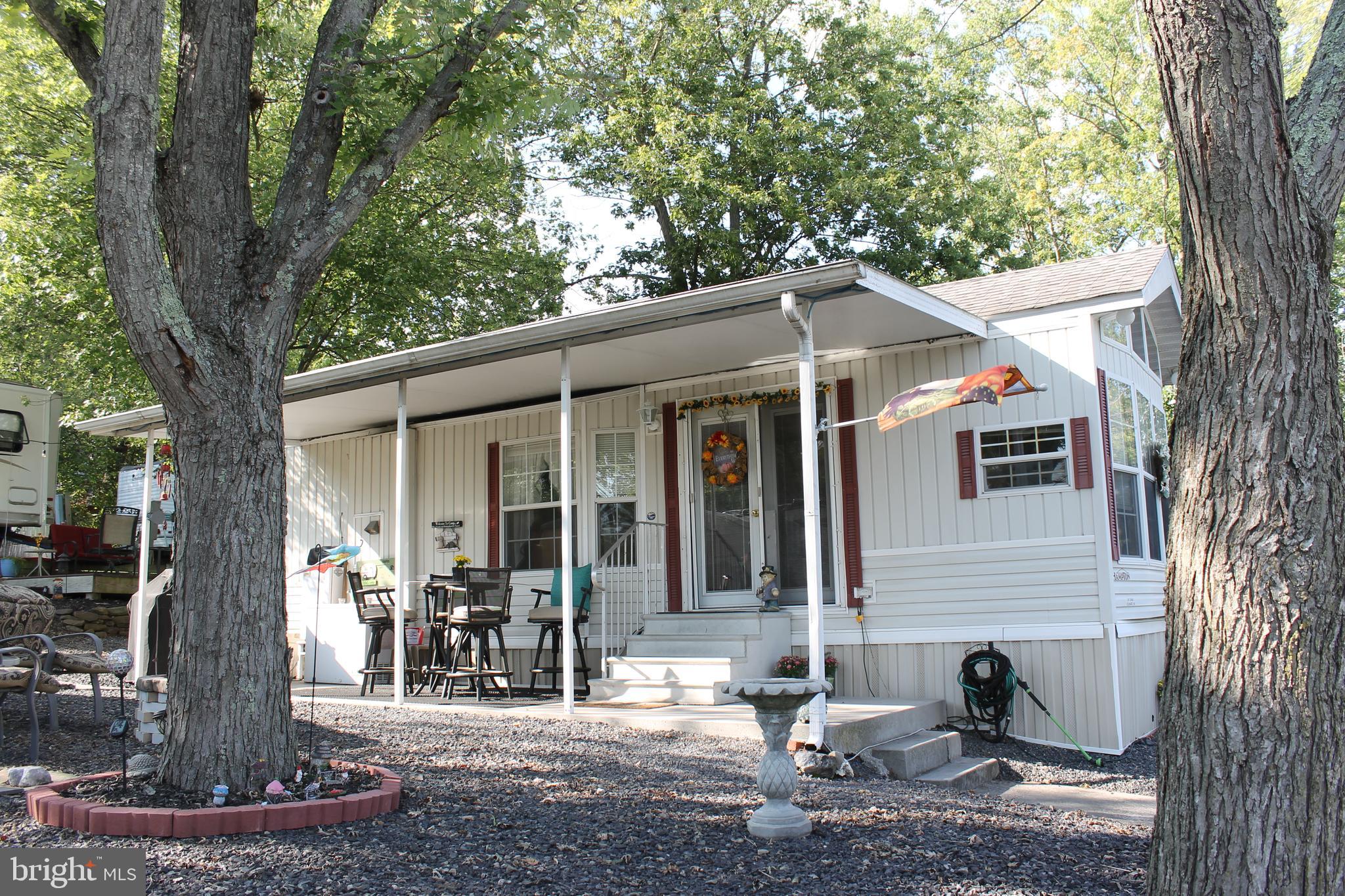 Wonderfully maintained SEASONAL RETREAT just minutes from historic downtown Gettysburg!  This 1 BR, 1 BA mobile is an ideal way to maximize your stay in Adams County.   Vaulted ceilings, open floor plan,  full kitchen, ceiling fans, laundry in unit, outdoor living spaces (covered patio, composite deck, campfire setting) and campground amenities let you enjoy summer fun day and night!  Pets allowed.  The Living Room has an accordion door to accommodate an additional sleeping area.   Starting November 1, 2024, the campground will no longer offer Annual Campsites.  Thus, this Annual Campsite will become a Seasonal Campsite once it transfers to the new owner.  Seasonal refers to the April thru October timeframe.  Starting November 2023, this campsite will be on a month to month lease for the current owner.  Buyer must be approved by Round Top Campground.  Extensive amenities make this a desirable locale; amenities include an inground swimming pool, separate kiddie pool, new mini golf, horseshoes, playground, outdoor movie theatre and so much more.  Showings are limited between 0330pm-0630PM all days.