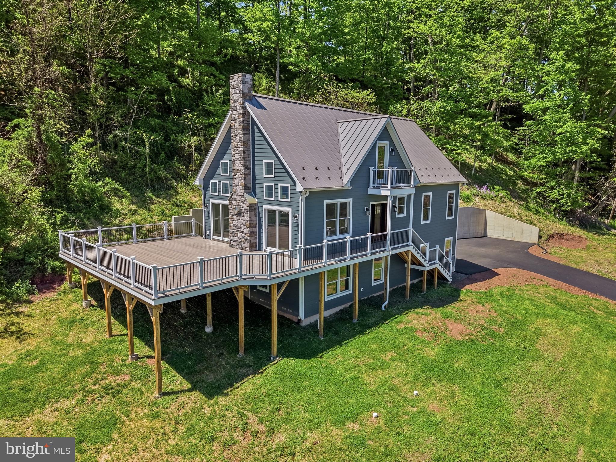 Located in the serene riverfront setting of Erwinna, this brand-new construction home offers a thoughtfully designed layout. The exterior showcases quality craftsmanship with Hardie Plank siding, a durable metal roof, and Andersen windows, all designed for long-lasting performance and protection. Inside, the home opens to a bright and inviting great room highlighted by vaulted ceilings that enhance the sense of space and natural light. A fireplace serves as the focal point, while sliding doors lead to a spacious wrap-around deck, perfect for entertaining, relaxing, or taking in the peaceful surroundings. The main level includes two generous size bedrooms, ideal for guests, family, or flexible use. Upstairs, a charming loft overlooks the main living area and features access to a private balcony with views toward the Delaware River. This versatile space works beautifully as a home office, reading nook, or additional lounge area. The second-floor primary suite offers a private retreat with an oversized closet and an en-suite bath complete with a soaking tub and walk-in shower, creating a comfortable space to unwind. The finished lower level adds valuable additional living space along with a convenient half bath, providing flexibility for recreation, work, or guests, and a large laundry room with ample storage. Enjoy a lifestyle that blends tranquility with convenience, just a short walk to a local winery, riverside dining, and access to the canal towpath with a kayak launch. Nearby river towns offer a vibrant taste of the arts, shopping, dining, and community events, along with access to parks and scenic outdoor recreation. Don’t miss this opportunity to own a custom riverfront home in a truly special location. Schedule your private tour today and experience all that river living has to offer.