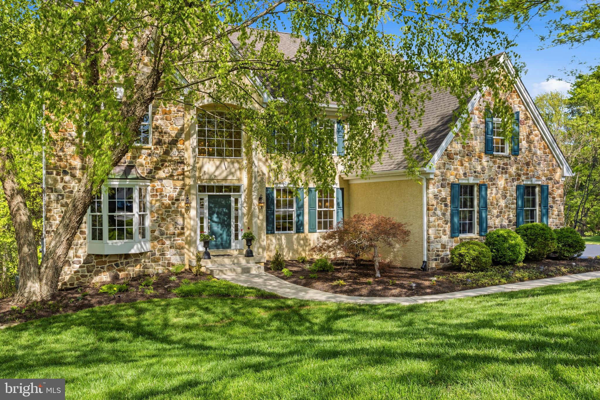 Nestled at the end of a private cul-de-sac in the prestigious Cherry Creek Conservation Community, this exceptional custom-built luxury residence offers 6 bedrooms, 4 full baths, 1 half bath, a finished walk-out lower level, and multiple flex spaces across more than three expansive levels of living space. Set on a beautifully landscaped .6-acre lot backing directly to protected woodlands and scenic walking trails, the property enjoys complete backyard privacy with no visible rear or side neighbors. Built in 2004 with timeless architecture and exceptional craftsmanship, the home showcases authentic Pennsylvania field stone, steep-pitched rooflines, premium Andersen windows and doors, Brazilian cherry hardwood flooring, soaring ceilings, extensive custom millwork, elegant architectural archways, and abundant natural light throughout.
The dramatic two-story foyer with a grand butterfly staircase opens to elegant formal living and dining rooms, while the breathtaking family room showcases vaulted ceilings and a floor-to-ceiling Pennsylvania field stone fireplace framed by oversized windows with arched transoms. A private first-floor office provides the ideal work-from-home setup.
Designed for both everyday living and entertaining, the gourmet kitchen features Perla Cream Century cabinetry, Uba Tuba granite countertops, stainless steel appliances, double wall ovens, a five-burner cooktop with decorative grotto hood, oversized center island, pantry, secretary station, and spacious breakfast area overlooking the private rear yard. A functional mudroom includes a laundry area and dedicated dog wash station.
Upstairs, the luxurious owner’s suite offers a stepped tray ceiling, separate sitting room or secondary office, dual walk-in closets, and a spa-inspired bath complete with soaking tub, oversized tiled shower, dual vanities, and peaceful woodland views. Four additional generously sized bedrooms complete the upper level, including a Jack-and-Jill suite and an additional hall bath.
The finished walk-out lower level dramatically expands the home’s versatility with a custom wet bar, theater room, marble-floored second family room, private sixth bedroom or in-law suite with full spa bath, plus an additional flex room ideal as a potential guest room, gym, hobby or art studio, playroom, or second office. With nine full-size windows and direct outdoor access, the lower level lives like an additional main floor.
Outdoor living is equally impressive, featuring an expanded rear deck with spa-style seating, beautifully landscaped walk-out patio, stone retaining walls, custom fire pit, colorful gardens, and an expansive flat backyard surrounded by mature trees.
Located within the award-winning West Chester Area School District, including Bayard Rustin High School, and just minutes from West Chester Borough, the Main Line, Philadelphia International Airport, tax-free Delaware shopping, and major commuter routes including Routes 202, 1, 322, and I-95, this extraordinary home combines luxury, privacy, flexible living space, and one of the Brandywine Valley’s most desirable conservation community settings.