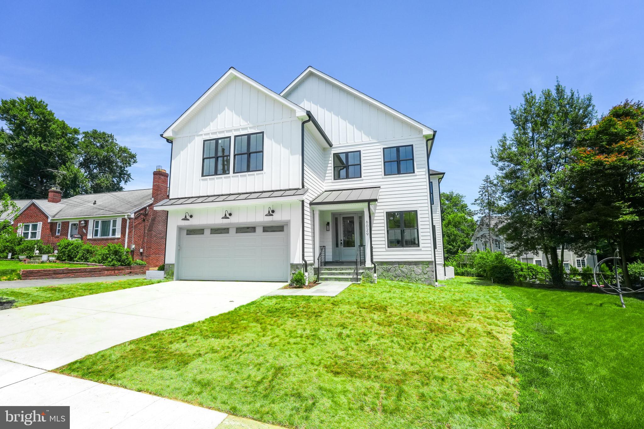 Welcome to your brand-new luxury home nestled in the heart of North Arlington. This stunning residence offers an impressive 5,500+ square feet of living space across three beautifully finished levels, featuring 5 bedrooms, 5.5 baths, and a spacious 2-car garage. Situated on a premium, generously sized flat lot within a serene cul-de-sac, this home is designed to impress. As you step through the front door, you'll be greeted by an inviting foyer that sets the tone for the rest of the home. The open floor plan is bathed in natural light from the abundant windows, highlighting the gleaming wide white oak hardwood floors and fresh paint throughout. Custom light fixtures, elegant crown molding, and meticulous attention to detail enhance the luxurious feel of this home. The main level boasts a versatile office with access to a full bath, perfect for remote work or guests. The hallway leads to a spacious dining room adorned with a stunning chandelier, providing an ideal space for formal gatherings. Adjacent to the dining room, you'll find a convenient scullery that flows into the breathtaking U-shaped dream kitchen. This chef's paradise features a large waterfall island with breakfast bar seating, chic navy cabinets with polished chrome handles, and top-of-the-line stainless steel appliances, including a gas range with a pot-filler, white quartz countertops with grey veins, and a classic subway tile backsplash. Opposite the kitchen is an expansive living area centered around a cozy gas fireplace, perfect for relaxing evenings. Sliding glass doors between the kitchen and living area open to stairs to the backyard, offering seamless indoor-outdoor living and entertaining. A well-appointed mudroom with built-ins and a washer/dryer hookup adds to the main level's functionality. Upstairs, the high ceilings continue, creating an airy and spacious feel. The owner's suite is a true retreat, featuring a luxurious en-suite bath with double corner vanities, abundant cabinet space, a separate soaking tub, and a spa-like shower. The suite also includes a massive walk-in closet. Three additional generously sized bedrooms are located on this level, including one with an en-suite full bath and two that share a Jack-and-Jill bathroom. A secondary laundry room with another set of washer and dryer and built-in cabinets provides added convenience. The fully finished walk-up lower level is an entertainer's dream, complete with a huge recreation room, a gorgeous wet bar, a fifth bedroom, a full bath, and a dedicated movie room. The beautifully landscaped yard enhances the home's curb appeal and offers a serene outdoor oasis. This home is conveniently located near major routes (Rt. 29, I-66, Glebe Rd.), East Falls Church Metro, and an array of shops, entertainment, and restaurants in Arlington. It's also situated within the highly regarded Nottingham Elementary, Williamsburg Middle, and Yorktown High school districts. Experience the pinnacle of luxury living in this exquisite North Arlington home. Welcome to your new dream home!