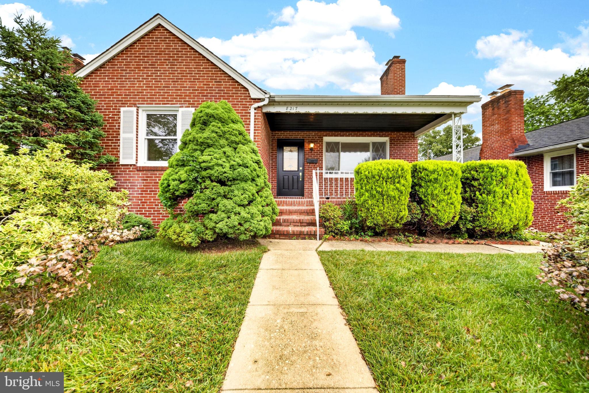 Pristinely manicured inside and out, this move-in-ready 5BR/2BA brick Cape Cod is located in a quiet neighborhood of Parkville. Park just steps from the landscaped front yard, then make your way to the covered front porch and the door into your forever home. Step inside a home filled with natural light, stunning hardwood floors, recessed lighting, an open floor plan, and a neutral color palette.  The main living area features a large living room with an extra-large picture window and a glamorous wood-burning fireplace, opening to the dining room and gorgeous kitchen. The kitchen features mixed metals with gold accents and stainless steel appliances including a slide-in gas range with a stainless range hood, sleek quartz countertops extending to the backsplash, a deep stainless sink under a window, cabinets with crown moldings, and a large island with breakfast seating and modern under cabinet lighting.  Down the hall are two spacious main-floor bedrooms with a stunning, updated full bath.  On the upper floor are two similarly sized bedrooms with new carpeting and hidden storage.  The lower level offers additional living space featuring an exposed beam ceiling, luxury flooring, a large recreation room, an additional room ideal as a guest bedroom or home office, a full bath with a walk-in shower, laundry, storage, and a walk-out to the lush green lawn in the yard.  From the main floor step outside to a semi-fenced yard offering tons of green space and possibilities.  This move-in-ready home is ideal for any new homeowner and is located near shopping, restaurants, and commuter routes.