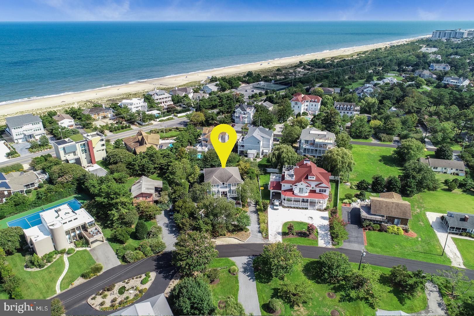 Introducing 30 Harbor Road located in the sought-after and amenity rich community of North Shores and only steps from the private beach, marina, pool and athletic courts. This stunning coastal home's mature landscaping complete with custom lighting and hardscape offer a very welcoming first impression. The rear exterior living is sure impress with a gorgeous in-ground pool surrounded by beautifully landscaped private gardens. Coastal elegance describes this home's interior decorated with custom tile work, ornate woodwork and designer finishes at every turn. The first level features 3 spacious bedrooms, including the master, 2 baths and a laundry area. The luxurious master bedroom is flooded with natural light and features a cozy sitting area, access to the rear balcony and an exquisite master bath complete with a spa-like shower, marble vanities and a relaxing jetted soaking tub. As you approach the second level, you will be wowed by the detailed woodwork on the railings and the custom built-ins. This level boasts an open floor plan featuring a sizable great room with a gas fireplace and wet bar creating the ideal space for entertaining. The dining area features a unique tongue and groove ceiling and is open to the gourmet kitchen with stainless appliances, granite counters, tiled backsplash, prep island and a dumbwaiter for convenience. In addition, a spacious guest suite with access to the rear balcony and a comfortable den or executive office complete with custom cabinetry, a room that could easily be converted to 5th bedroom. 30 Harbor does not end here, this home's ground level offers a living area and 2 more bedrooms with en-suite baths and a half bath with easy access to the pool deck. With 6 bedrooms, 5.5 baths in all, comfortable interior spaces and beautiful outdoor living too, this home will not disappoint.