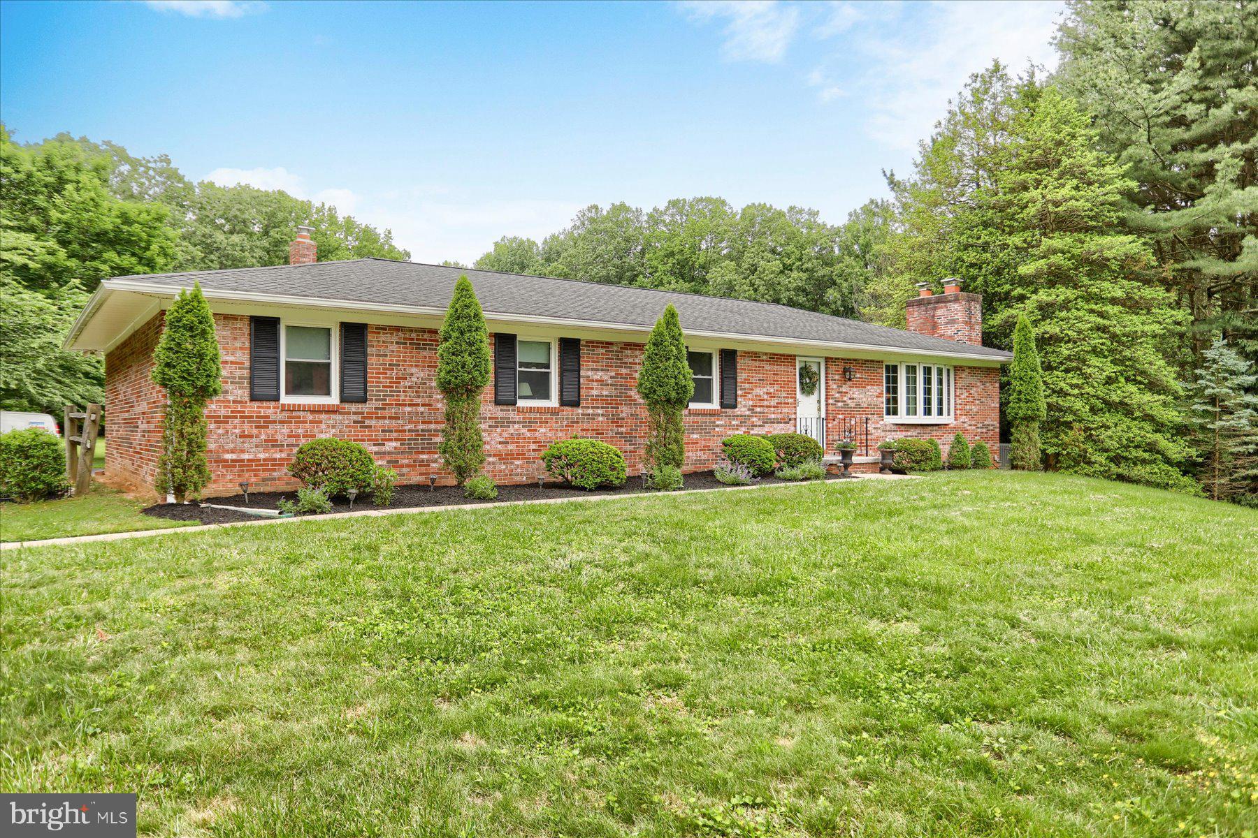 Discover your nature lover's dream: an all-brick rancher nestled on a picturesque 2.26-acre lot in the highly sought-after Hereford School Zone. This home offers  desirable one-level living and is perfectly situated on a quiet cul-de-sac, backing directly to the pristine Pretty Boy Dam reservoir and surrounded by Maryland's lush, rolling countryside.

The kitchen is a culinary delight, updated with quartz countertops and stainless steel appliances. Sunlight streams through the beautiful bow windows in the living and dining rooms, highlighting the gleaming wood floors. Unwind by the beautiful stone fireplace in the living room. Significant recent updates provide peace of mind, including an architectural roof from 2018, a new heat pump in 2022, and a completely rebuilt oil burner in 2023.  The finished lower level includes a huge family room with a wood-burning stove and space for a pool table or ping pong table. The property is a nature enthusiast's paradise, featuring a large 33 x 12 Trek Decking from 2019.  In the rear of the property is a massive three-bay outbuilding, perfect for projects or for car enthusiasts, including one bay with a concrete pit.  Enjoy a lifestyle connected to nature, with the NCR Hike and bike trail nearby. The location provides easy access to local farm stands for fresh produce, and is just a short drive from Hunt Valley Town Center for shopping and dining, and fine dining venues like The Milton Inn or the Oregon Grille.