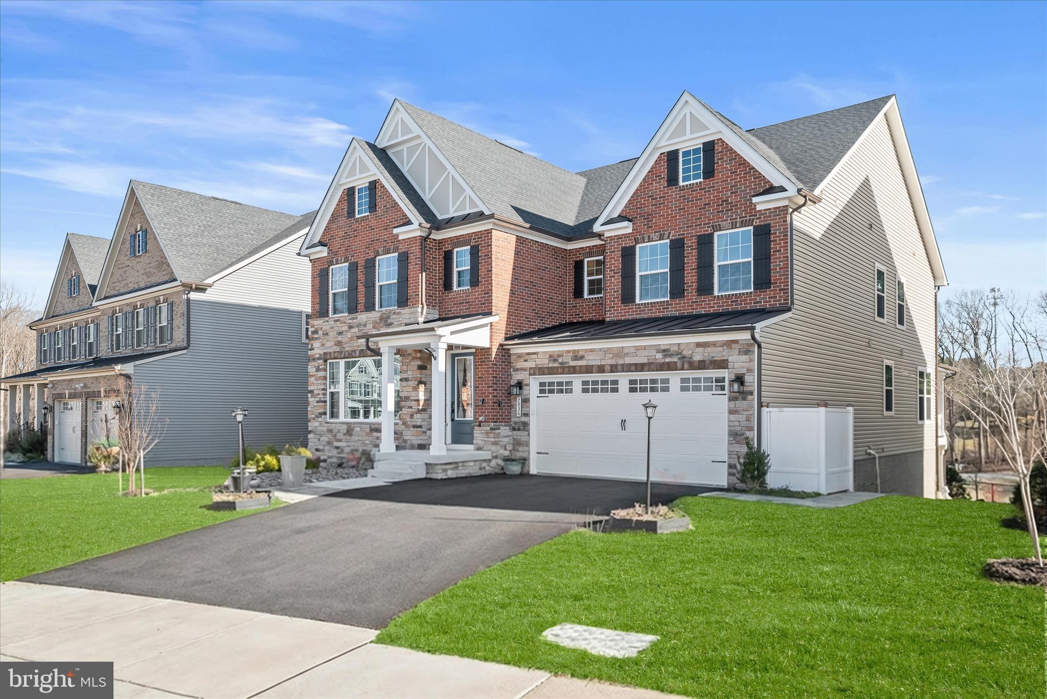 Located in the coveted Cedar Creek community of Columbia, Maryland, this exceptional Colonial-Craftsman residence offers a tranquil setting surrounded by nature while delivering the refined finishes and expansive living spaces expected in luxury living. From the moment you step inside, the open yet traditionally inspired floor plan welcomes you with thoughtful design and elegant details throughout.  The foyer, featuring luxury vinyl plank flooring and crown molding that extends across the main level, sets a sophisticated tone. Just off the entry, a private bedroom suite offers ideal accommodations for guests or multigenerational living, while a glass French-door office provides a bright and stylish workspace. The living room is bathed in natural light and enhanced by a calming neutral palette, creating an inviting and refined atmosphere.  Designed for effortless entertaining, the dining area flows seamlessly into the gourmet kitchen and provides direct access to the covered deck, where peaceful wooded views create the perfect backdrop for indoor-outdoor living. The chef’s kitchen showcases a spacious center island with breakfast bar seating, quartz countertops, stainless steel appliances, a double wall oven, a striking geometric backsplash, pendant lighting, and 41” soft-close cabinetry, along with a sizable pantry and convenient access to the mudroom and two-car garage.  The luxurious primary suite is privately positioned behind French doors and features a tray ceiling with crown molding, plush carpeting, and two expansive walk-in closets. The spa-inspired en-suite bath offers separate vanities, a glass-enclosed walk-in shower with ceramic tile surround, and a jetted soaking tub designed for relaxation.  Upstairs, a versatile loft provides the perfect setting for movie nights or a gaming lounge. Two bedrooms with walk-in closets share a dual-entry bath, while an additional bedroom suite with its own walk-in closet completes the upper-level sleeping quarters.  The fully finished lower level expands the home’s versatility with a spacious family room featuring a wet bar with 42” cabinetry and dishwasher, plus direct access to the patio for seamless entertaining. A recreation area, an additional bedroom, and a full bath complete this level.  Constructed with an elegant blend of stone, brick, and vinyl siding, this home perfectly balances timeless architecture with modern comfort. Ideally located near major commuter routes, including US-29, I-70, and I-95, residents enjoy convenient access to both Baltimore, Maryland, and Washington, D.C. while enjoying the peaceful surroundings that make Cedar Creek one of Columbia’s most desirable communities.