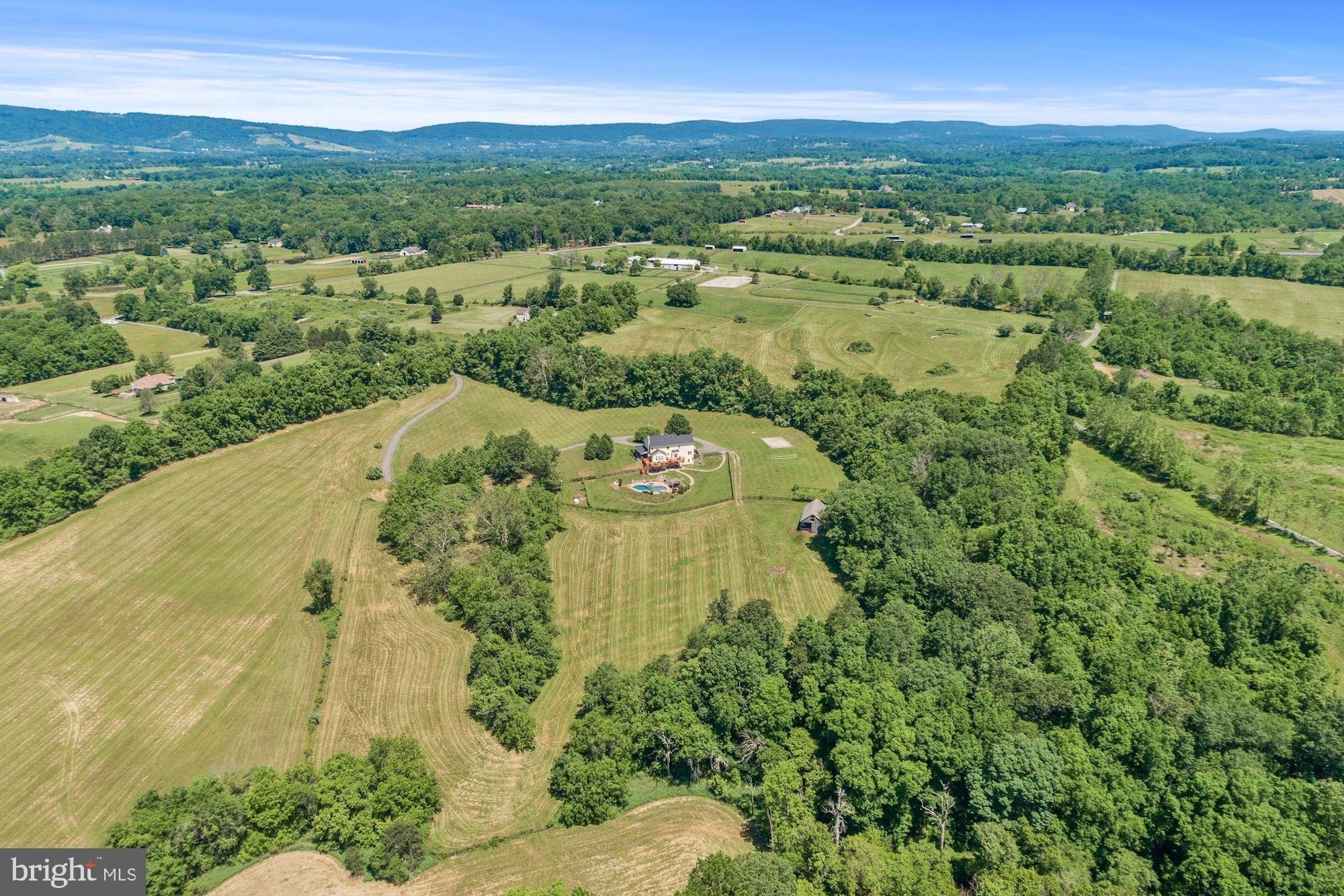 Sweeping pastoral views from this hidden gem located just a few miles south of Purcellville, comprising 29.53 acres. The location also offers additional scope for equine, winery or hospitality use and has in the recent past operated as a successful Airbnb destination.  5 bedroom, 5.5 bathroom home with fully renovated and self-contained lower level apartment offering additional living space. Wrap around high quality porch with stunning views of the private, surrounding landscape. Equine amenities include 4 stall barn, pastures, access to Beaver Dam Creek and several site options for an outdoor arena. Beautiful heated pool with hard landscape and hot tub. Newly painted stucco exterior with new roofing. The property comprises 2 separate tax id parcels, 563265831000 (15.23 acres) and 563163567000 (14.3 acres) with potential to build a second home, sell the adjoining parcel and/or consider a conservation easement. Viewing highly recommended to appreciate the serene ambience, all within reach of the DC metro commute and without the need to access any gravel roads! All appointments must be scheduled with the listing agent.