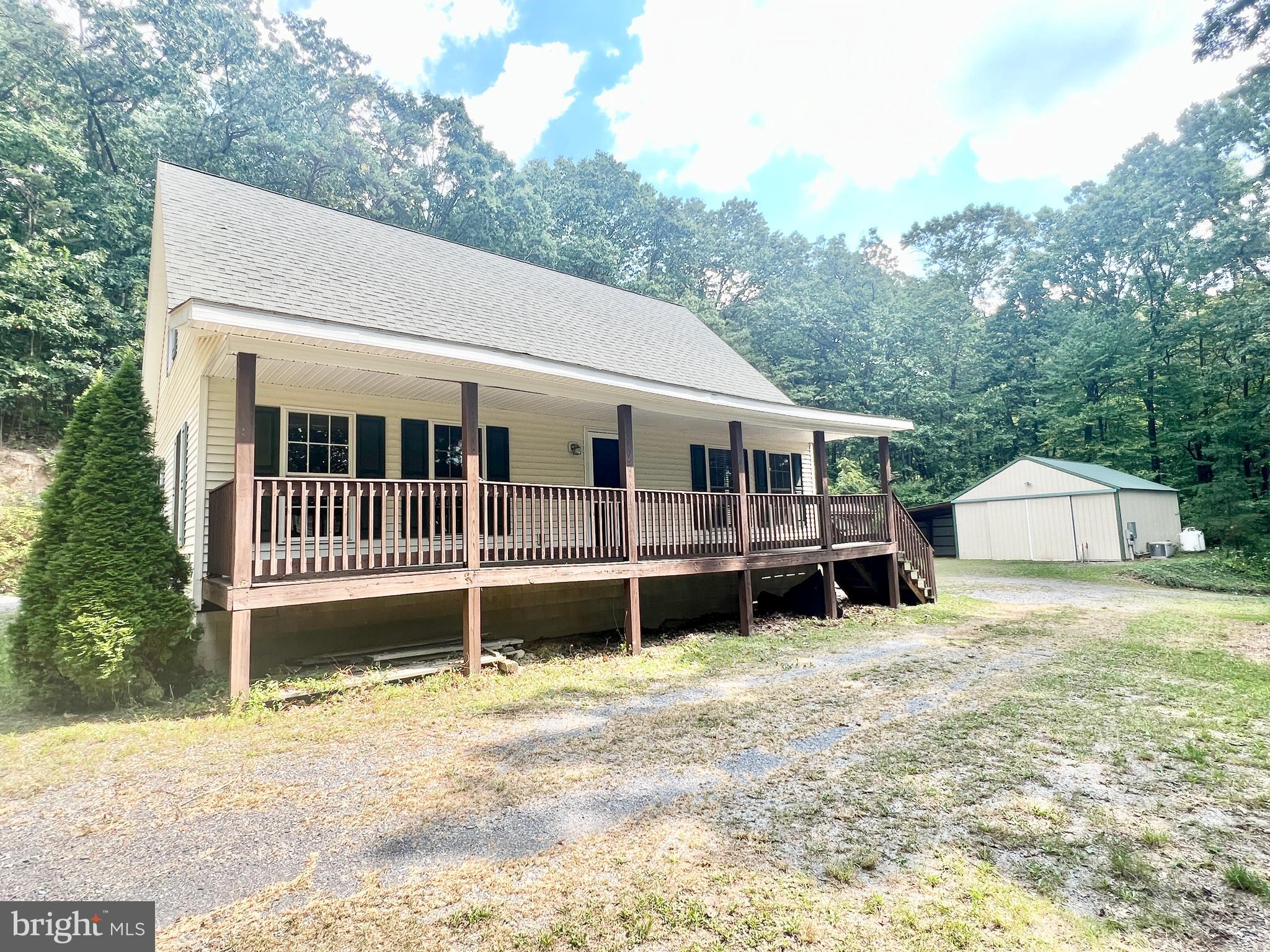 Secluded 2 Bedroom, 2.5 bath home nestled in the woods resting on 4.4+/- acres. The main floor of the home offers a living room, eat-in kitchen, primary bedroom, and 1.5 baths. The second floor offers a bedroom, full bath, and a bonus storage area that could be finished to be a 3rd bedroom. Outside you will find a covered porch, 24' x 32' garage, multiple sheds, gazebo, &  whole house generator. The property offers easy access to I-70 & PA Turnpike.