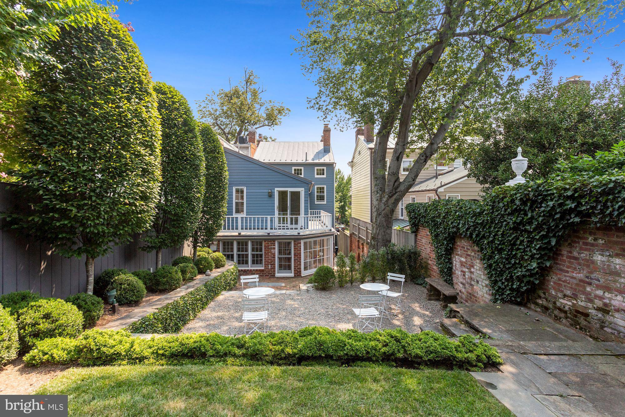 This charming semi detached residence has been updated in the last five years and features a professionally designed and landscaped deep and private Georgetown Garden, Terrace and water feature. The main level is comprised of a gracious Foyer, large double Living Room with two fireplaces,  entertaining size Dining Room with wall of glass and fireplace, Powder Room, table space Kitchen with stainless appliances & white Corain counters and French doors & wall of south facing windows to & overlook Garden. The Second Floor with Primary Bedroom with ensuite Bath & Sitting Room overlook Garden, two additional Bedrooms & Hall Bath.  A Third Floor has two more Bedrooms & a Hall Bath. The Lower Level with plentiful Storage, Utility Room, Laundry Area and Half Bath.  Open Sunday 9/19  2:30 to 4:00