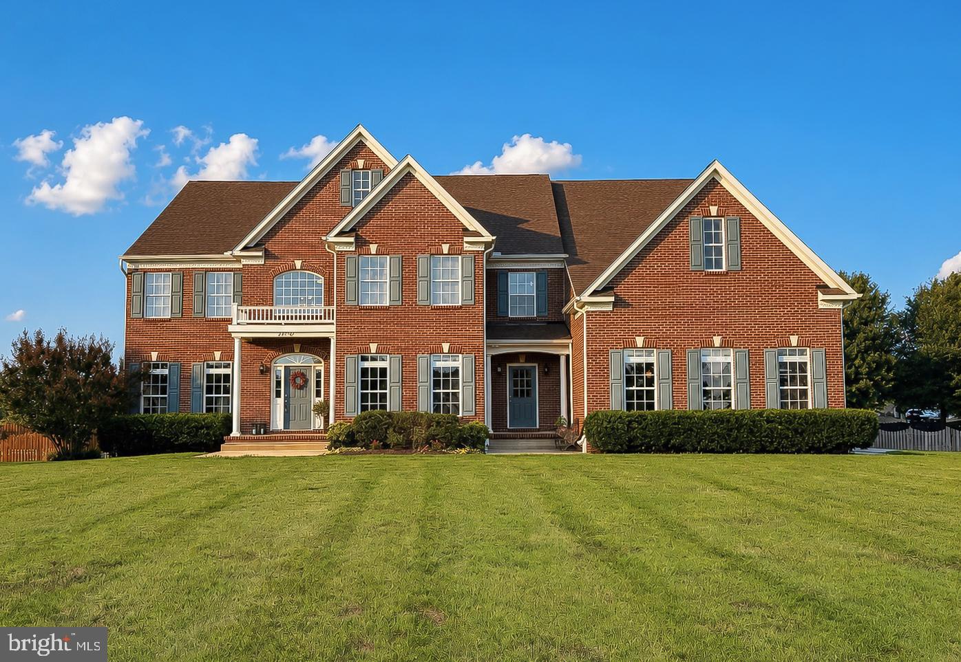 Welcome home to this stunning luxury residence in the sought-after Leonardtown Farms neighborhood, offering over 5000 finished square feet! Built and impeccably maintained by its original owners, this home feels brand new; not a detail has been overlooked. A detailed record of every upgrade and maintenance item from 2012 through 2026 is available, giving buyers complete peace of mind and a clear history of care.
A two story entry foyer and grand staircase greet you upon arrival, with a formal dining room to the right and a formal living room or office to the left, ideal as a flex space to suit your needs. A second staircase off the back of the home offers everyday convenience and flow. The main level also features a spacious family room large enough for oversized furniture. Gorgeous hardwood floors grace the main level, with upgraded flooring throughout the rest of the home and custom paint that still looks brand new.
The kitchen is a true chef’s dream: a walk-in pantry plus a separate butler’s pantry with wine storage and a mini fridge offer exceptional storage, while two sinks (one for everyday use and a separate prep sink) make meal prep effortless. A double wall oven, cooktop, and stainless steel appliances complete the space, along with a counter bar big enough to seat six. Expansive cabinets and gorgeous granite counter tops make this a true show stopper. A huge office and workstation area sits just off the kitchen, complete with built-in cabinetry and double desks, perfect for homework, remote work, or managing the household.
The main floor bedroom offers its own private outside entrance and full bath, ideal as an in-law suite, guest quarters, or a private retreat completely separate from the rest of the home.
A third entrance leads into a spacious mudroom and laundry room combination, perfect for coming in from yard work without tracking through the main living areas. The three car side load garage offers ample room for vehicles and storage.
Upstairs, the expansive primary suite is a true retreat, featuring a separate sitting area large enough to serve as a workout space, nursery, or additional home office. The en suite bath includes a tiled shower with dual shower heads, his and her sinks, and a jetted tub. Two additional bedrooms share a convenient Jack and Jill bath with two separate sink areas so there is no fighting over space, and a fourth bedroom enjoys a private bath of its own. A versatile rec room adds even more flexibility, perfect as a playroom, additional bedroom, or office.
Still want more room to grow? The massive unfinished basement (over 2200 sqft) offers exceptional storage and future expansion potential, while the FROG (finished room over garage) is framed and ready to complete, with subfloor, walls, and electric already in place.
Outside, the open, flat lot just under an acre offers a backyard ready for a pool, with the septic system located in the front yard to keep your outdoor living space open and unobstructed.
As the youngest home in the neighborhood, this property offers four full baths, one half bath, and modern construction with room to make it your own. Both HVAC systems were replaced in 2023
Schedule your private tour today; a home like this does not come along often.