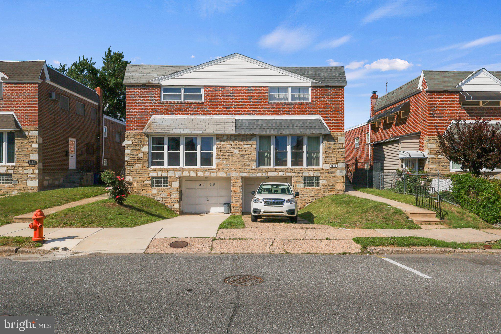 Welcome to 2127 Hoffnagle Street, a rarely offered, stone-front split-level twin home delivering exceptionally designed living space. Perfectly situated on a quiet residential street in the highly desirable Rhawnhurst/Bells Corner section of Northeast Philadelphia, this home’s unique multi-level footprint offers unmatched versatility—making it an absolute dream for growing families, multi-generational living, or those who love to entertain.

An Inviting Main Floor: Step inside to a bright and airy main level, anchored by a massive front picture window that floods the seamless living and dining areas with beautiful natural light. Just off the dining room is the beautifully updated, eat-in kitchen. Designed with both style and function in mind, it boasts extensive custom-made cabinetry, generous counter space for effortless meal prep, and ample room for a casual family dining table.

Private Tiers of Bedrooms: Spanning the upper tiers of the home are four generously sized bedrooms and two full bathrooms, offering excellent privacy and separation for everyone in the household. The first upper tier features two bright bedrooms with ample closet space and a meticulously maintained full hall bath. Just a flight above, you will find a peaceful retreat: an oversized master bedroom, a fourth large bedroom, a convenient hallway linen closet, and a second immaculate full bathroom.

The Ultimate Flex-Space Ground Floor: Just one flight down from the main living area, the ground level features a sprawling family room that can easily serve as a secondary lounge, guest quarters, or an ideal in-law suite. This level also includes a separate, quiet room perfectly suited for a dedicated home office, study, or craft space. Best of all, this level walks out directly to a spacious, private rear yard—the ultimate setting for weekend barbecues and outdoor relaxation. A convenient half bathroom completes this floor.

Finished Basement with a Bonus Second Kitchen: The lower basement level maximizes the home's functionality, offering a fully finished space equipped with a full laundry area and a highly valuable second kitchen—perfect for holiday meal prep, catering, or use as a summer kitchen. This level also provides seamless, direct interior access to your private driveway and the attached 1-car garage.

Turn-Key Updates for Total Peace of Mind:
Meticulously cared for, this home features top-tier capital improvements already completed by the owners:
* Brand New Water Heater (April 2026)
* New HVAC System (2024) for worry-free, central air-conditioned comfort
* Three New Exterior Doors with Storm Doors (2020)
* New Garage Door (2019)
* Replacement Windows Throughout (2018)

The Perfect Location:
Enjoy the very best of peaceful residential living paired with city convenience. This home sits within easy walking distance of public transportation, a neighborhood elementary school, and a vibrant variety of local shops and dining. Plus, outdoor enthusiasts will love the close, convenient access to the scenic hiking and biking trails of Pennypack Park. Don't miss this rare neighborhood gem—schedule your tour today!
