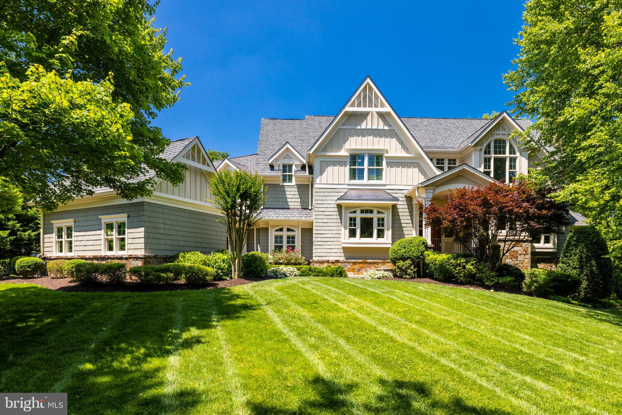Custom built Transitional colonial in sought after Langley Farms handsomely sited on over one half acres and located just minutes to Washington DC, Tysons, Dulles Tech Corridor and Bethesda MD. This spacious home boasts approximately 9300 sf of light filled living space with 6 bedrooms and 9 baths and four fireplaces and ten foot ceilings on all three levels. Built in 2007 this lovely home has been completely refreshed with new designer light fixtures, neutrally painted throughout, refinished hardwood floors and luxury vinyl in the lower level makes this home shine. The thoughtful floor plan was designed to provide seamless flow for entertainment inside to the outside. The front entrance features a barrel ceiling portico leading into the two story foyer flanked by the formal living and dining rooms and offers direct views of the backyard. The study is privately located off the family room and has built-ins and great views of the neighborhood. The family room with a coffered ceiling is centrally located with the corner stone fireplace as the focal point. The adjoining gourmet kitchen has a large center island, loads of cabinetry and fully equipped for cooking and entertaining including a large walk-in pantry. The family entrance offers a very spacious mudroom with built-in cubbies. The upper level features the owner's suite with a luxury bath, two spacious walk-in closets with custom built-ins and a balcony overlooking the backyard.  There are four additional bedrooms that are all en suites.  The upper level is complete with a family lounge area and laundry room. The open lower level is an entertainment haven with a large recreation room with fireplace and a complete bar, play nook, exercise room, billiard room, bedroom with attached full bath, powder room and huge storage room. This lovely home is beautifully sited on a lushly landscaped lot with a private backyard that features an expansive stone patio with a pergola, stone fireplace, and stone bar with a grill. There is a two car attached garage and one car detached garage with a covered walkway to the family entrance.

Langley Forest is in a very sought after location just a short distance to Tysons, the Dulles Tech Corridor, Bethesda and the GW Parkway to Washington DC and equidistant to Reagan National and Dulles International Airports. This neighborhood is privately tucked off Georgetown Pike within a short walk to Scotts Run hiking trails and minutes to Great Falls National Parks. Nearby year round attractions include Capital One Hall Performing Arts Center, Wolftrap National Park for the Performing Arts, Tysons Corner Mall and the Galleria as well as The Boro.  For children there is the McLean Central Park with the McLean Library and the Community Center as well as the amazing Clemyjontri Park which features a playground for children of all abilities.