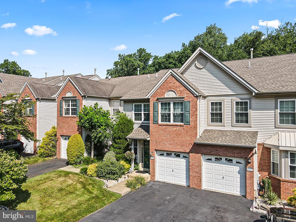 Wow! Absolutely beautiful home in The Clusters of Gravel Hill, a desirable Southampton community known for its attractive brick exteriors, mature landscaping, and convenient location. Meticulously maintained and thoughtfully upgraded, this impressive residence combines elegant finishes, generous living spaces, and a peaceful setting that backs to mature woods. The open-concept main level is filled with natural light and features hardwood flooring, crown molding throughout the home, and recessed lighting. The upgraded kitchen offers granite countertops, quality appliances, abundant cabinet and workspace, and sliding glass doors leading to the rear deck. The kitchen flows seamlessly into the dramatic two-story family room, where a gas fireplace creates a warm and inviting focal point. Hardwood flooring continues throughout the second floor. The spacious primary bedroom suite is a luxurious private retreat featuring a cathedral ceiling, separate sitting room, walk-in closet with custom cabinetry, and a beautifully remodeled full bathroom. An additional hall bathroom has also been tastefully remodeled, while the conveniently located second-floor laundry room adds everyday functionality. The finished walk-out basement provides valuable additional living and entertaining space with tile flooring, recessed lighting, a large storage closet, and sliding glass doors opening to the rear patio. Above, the maintenance-free Trex deck features an under-deck drainage system designed to help keep the patio below dry during rainy weather. Stairs connect the deck to the patio and backyard for easy access between the outdoor living areas. The private backyard backs to mature woods, creating a tranquil and secluded natural setting. Recent improvements include a new roof installed in 2021, replacement windows and two new screen doors installed in 2023, the Trex deck, remodeled bathrooms, and an updated staircase railing. Additional highlights include a whole house water filtration system, central vacuum system, a one-car garage with interior access, a driveway with parking for two vehicles, and ample additional parking in front of the home. Beautifully cared for with exceptional attention to detail and luxury upgrades, this outstanding property offers comfort, style, and privacy within easy reach of shopping, dining, and major highways.