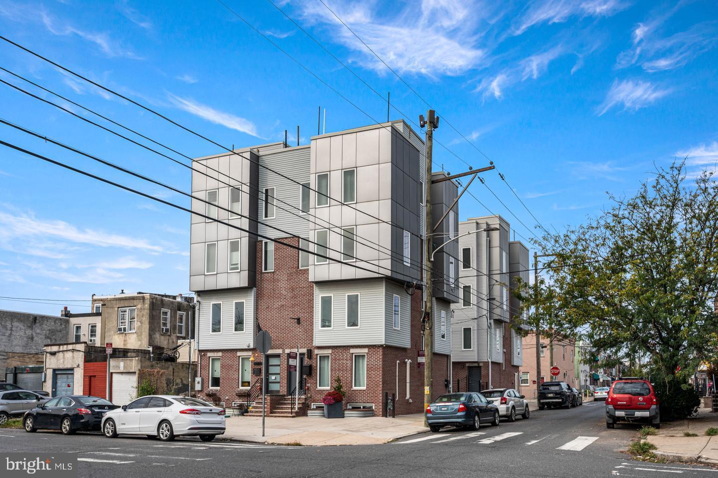 Welcome to 2002 E. Moyamensing Avenue, a stunning newer-construction residence tucked within The Fourth, one of South Philadelphia’s most sought-after gated courtyard communities. Built in 2018 and offering 3 bedrooms, 2.5 bathrooms, a finished basement, rear-entry garage, and breathtaking skyline views, this exceptional home blends sophisticated design with everyday convenience.

Beyond the motorized gate entrance on McKean Street, residents enjoy the privacy and exclusivity to the community’s garages and driveway courtyard. Inside, a spacious foyer makes an impressive first impression, featuring a large coat closet, powder room, direct access to the attached garage which features additional storage, and striking floating staircases that set the tone for the home's modern architectural aesthetic.

Designed with both entertaining and everyday living in mind, the second floor showcases an expansive open-concept layout centered around a showstopping chef’s kitchen. A massive quartz waterfall island anchors the space, offering abundant prep space and bar seating, while white shaker cabinetry, stainless steel appliances, and a sleek gray glass subway tile backsplash create a timeless yet contemporary design. The kitchen seamlessly connects the dining and family room areas; all bathed in natural light from oversized windows.

The third level features two generously sized guest bedrooms with ample closet space, a well-appointed hall bathroom with a double vanity, and a conveniently located laundry room.

Occupying the entire fourth floor, the luxurious primary suite serves as a private retreat. The spacious bedroom is complemented by a custom walk-in closet with built-in organization systems and a spa-inspired bathroom featuring an oversized glass-enclosed shower, Jacuzzi soaking tub, double vanity, and floor-to-ceiling tile finishes.

Crowning the home is an expansive roof deck offering unobstructed panoramic views of the Philadelphia skyline, Lincoln Financial Field, and the Walt Whitman Bridge—an extraordinary setting for entertaining, relaxing, or taking in spectacular sunsets and fireworks displays throughout the year.

The finished basement level offers incredible flexibility, providing the perfect space for a home office, fitness studio, media room, additional living area, or guest overflow, along with storage options.

Additional highlights include hardwood flooring throughout the main living levels, tile flooring in the finished basement, an attached garage, and several years remaining on the tax abatement.

Ideally situated just steps from the vibrant dining, nightlife, and neighborhood favorites of East Passyunk and Pennsport, you'll enjoy easy access to local hotspots including Barcelona Wine Bar, Moonshine, Mifflin Tavern, Herman's Coffee, Pennsport Beer Boutique, and Bok Bar. Commuters will appreciate the convenient access to I-95, I-76, and nearby bridges connecting to New Jersey.

A rare opportunity to own a thoughtfully designed luxury residence in one of South Philadelphia’s premier gated communities, 2002 E. Moyamensing Avenue delivers elevated city living at its finest.