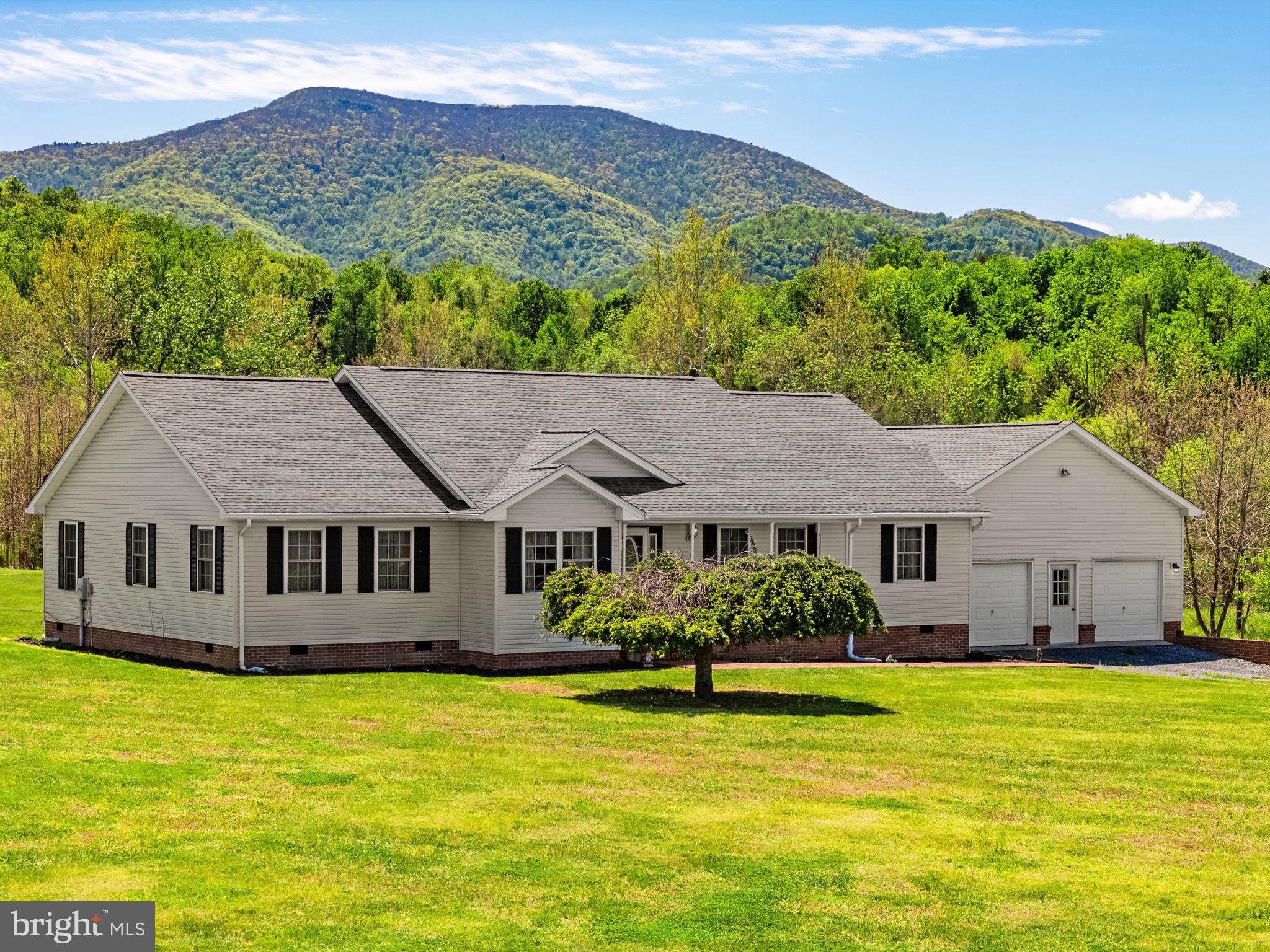Are you looking for quiet, mountain views and lots of living space? Look no further than 6315 Ida Rd!!!  Back on the market and improved, this home has been wonderfully maintained, and ready to move in, needing only those personal touches and upgrades that will make it an absolute showpiece. From the newly appointed front porch (New Railings and Posts 2026), new shutters (2026), New Dishwasher and New Disposal (both 2026)  and painted front door, you feel immediately at home. Walk in to a large Foyer space and a fairly unique layout, boasting large living spaces that give it an open floorplan feel, but in a traditional layout with ample room for your furniture and needs.  Whether in the Eat-In Kitchen that houses lots of cabinet space, plenty of room for dining room furniture and great options for cooking and entertainment, or in the oversized living room with a perfect nook for a future office or flex space, this home offers plenty of room.  Two modest sized bedrooms and a lovely primary suite with a large walk in closet provide the comfort of sleeping room, ample hobby space or an office. The oversized garage has plenty of room to make your own, and ample room right outside the door for anything you may care to add to the three plus acre property.  Want to step outside? Go out the back door onto the brand new large deck (2026) and take in the beauty that surrounds you. Between the quiet, the cool breeze and the mountains that surround you, this deck is the perfect place for a cup of coffee or evening beverage to take in all of the wonderful surroundings. This home was meant for entertaining, or relaxing... or both!  Care to see it for yourself? Make an appointment today!