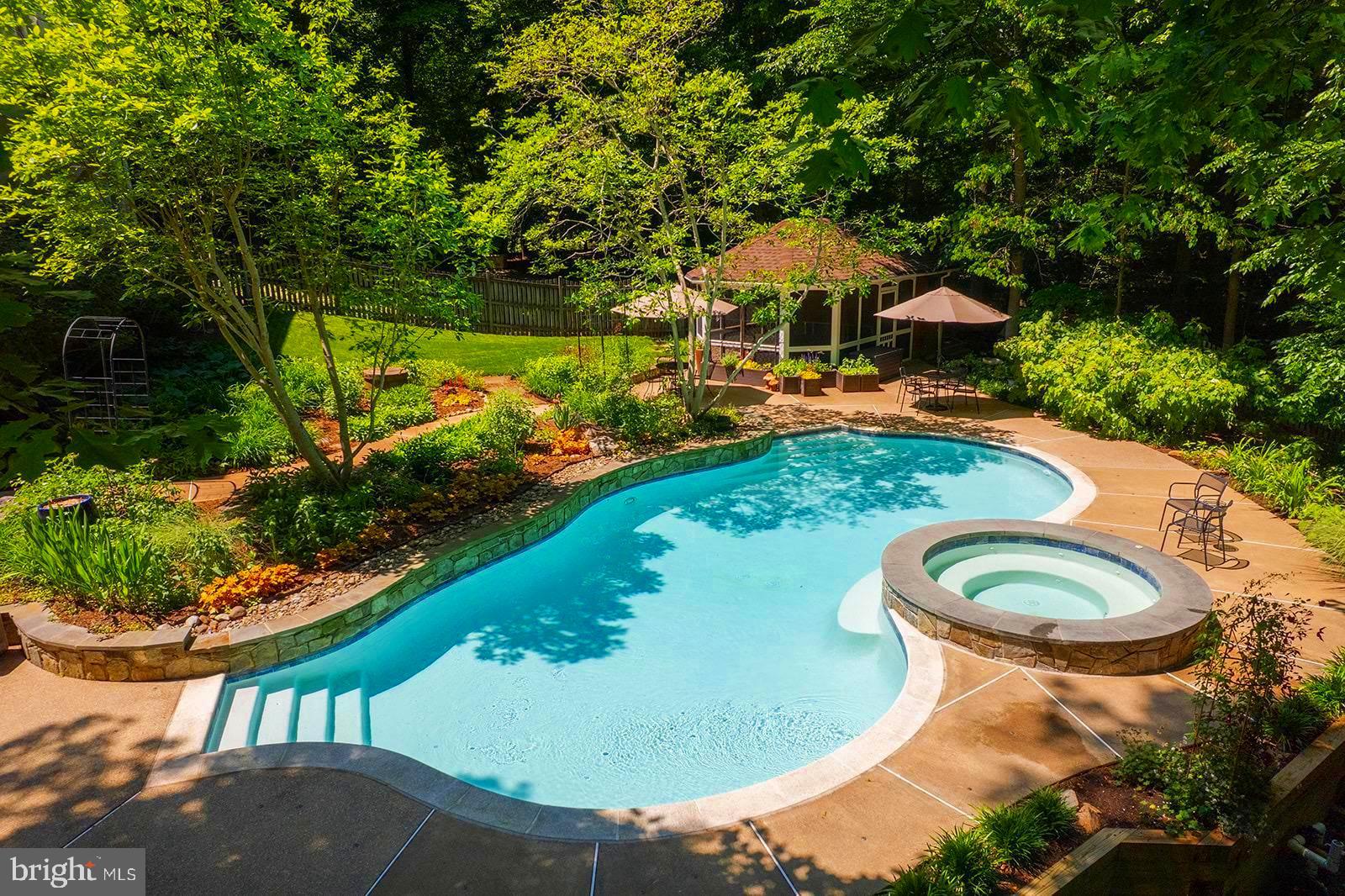 This is the ultimate relaxation spot that Dad wants for Father's Day!   Come spend Father's Day by the pool. 
 Open house Sunday, June 21st, 2-4pm.

<br>

Vacation at home in this Renaissance built Grand Renoir model that is perfectly sited on five acres overlooking Sandy Run, this extraordinary waterfront estate offers more than 7,000 finished square feet of living space in one of Fairfax Station's most picturesque settings. Surrounded by mature trees, lush landscaping, and abundant wildlife, the property delivers an exceptional sense of privacy and tranquility while remaining just minutes from parks, trails, commuter routes, and everyday conveniences.

<br>

This stately residence makes an impressive first impression, the home is filled with extraordinary natural light, soaring ceilings, and views from every window.  A dramatic two-story foyer welcomes guests and opens to gracious formal and informal spaces, the heart of the home is the beautifully renovated chef's kitchen, thoughtfully designed for gathering and entertaining, featuring gas cooking, abundant cabinetry, generous prep space, a walk-in pantry, and a spacious breakfast area. French doors open directly to the screened porch, creating an effortless connection between indoor and outdoor living. The adjacent family room is truly spectacular, highlighted by a floor-to-ceiling stone fireplace, walls of windows framing breathtaking views of the property, and a secondary staircase. A private office with serene views of the surrounding landscape, mudroom with optional main-level laundry, and powder room complete the main level.

<br> 

The upper level offers the highly sought-after four-bedroom, four-bath floor plan. The luxurious primary suite serves as a peaceful retreat, complete with a private balcony overlooking the estate, dual walk-in closets, and a refreshed spa-inspired bath with soaking tub and oversized shower. Three additional generously sized bedrooms on this level each enjoy their own private bath and beautiful views of the surrounding grounds.

<br>

The walk-out lower level was designed for entertaining, gathering or just relaxing. Featuring expansive recreation and billiards areas, a private fifth bedroom and full bath, a large laundry room, and extensive storage, this level offers remarkable flexibility to meet a variety of lifestyle needs.

<br>

Outside, a truly extraordinary resort-inspired oasis awaits. The sparkling pool and spa with waterfall feature serve as the centerpiece of the outdoor living experience, surrounded by extensive patios, multiple decks, a screened dining pavilion perfect for al fresco entertaining, enchanting gardens, and a sprawling level lawn for recreation and play.  The setting is simply magical. 

<br>

Lovingly maintained by its original owners, this exceptional residence has been meticulously cared for and improved throughout the years. Recent updates include LVP Flooring in the Lower Level (2026), HVAC (2024), Pool and Spa Replaster and Tile (2023), Driveway Expansion (2016), GAF Architectural Roof (2015), Kitchen Renovation (2014), Hardwood Flooring on the Upper Level and Office (2010), Oversized Gutters (2007), Pella Windows & Doors and numerous additional enhancements.

<br>

The location is equally impressive. Hampton Acres is one of Fairfax Station's most coveted communities, offering a unique blend of estate living and convenience. Residents enjoy easy access to Burke Lake Park, Fountainhead Regional Park and Marina, South Run Recreation Center, the Workhouse Arts Center, historic Occoquan, and the charming town of Clifton. Commuters will appreciate proximity to Route 123, I-95, I-66, Fort Belvoir, commuter lots, Pentagon bus service, Lorton VRE Station, Reagan National Airport, and Dulles International Airport.

<br>


All of this is served by the highly desirable Sangster Elementary and Lake Braddock Secondary School pyramid.