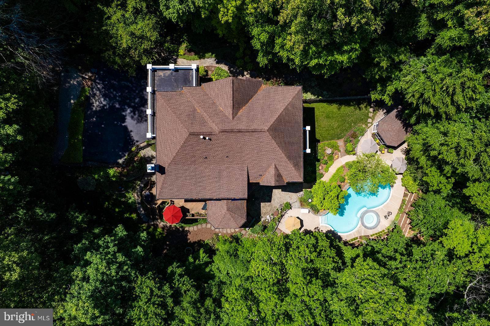 Vacation at home in this Renaissance built Grand Renoir model that is perfectly sited on five acres overlooking Sandy Run, this extraordinary waterfront estate offers more than 7,000 finished square feet of living space in one of Fairfax Station's most picturesque settings. Surrounded by mature trees, lush landscaping, and abundant wildlife, the property delivers an exceptional sense of privacy and tranquility while remaining just minutes from parks, trails, commuter routes, and everyday conveniences.

<br>

This stately residence makes an impressive first impression, the home is filled with extraordinary natural light, soaring ceilings, and views from every window.  A dramatic two-story foyer welcomes guests and opens to gracious formal and informal spaces, the heart of the home is the beautifully renovated chef's kitchen, thoughtfully designed for gathering and entertaining, featuring gas cooking, abundant cabinetry, generous prep space, a walk-in pantry, and a spacious breakfast area. French doors open directly to the screened porch, creating an effortless connection between indoor and outdoor living. The adjacent family room is truly spectacular, highlighted by a floor-to-ceiling stone fireplace, walls of windows framing breathtaking views of the property, and a secondary staircase. A private office with serene views of the surrounding landscape, mudroom with optional main-level laundry, and powder room complete the main level.

<br> 

The upper level offers the highly sought-after four-bedroom, four-bath floor plan. The luxurious primary suite serves as a peaceful retreat, complete with a private balcony overlooking the estate, dual walk-in closets, and a refreshed spa-inspired bath with soaking tub and oversized shower. Three additional generously sized bedrooms on this level each enjoy their own private bath and beautiful views of the surrounding grounds.

<br>

The walk-out lower level was designed for entertaining, gathering or just relaxing. Featuring expansive recreation and billiards areas, a private fifth bedroom and full bath, a large laundry room, and extensive storage, this level offers remarkable flexibility to meet a variety of lifestyle needs.

<br>

Outside, a truly extraordinary resort-inspired oasis awaits. The sparkling pool and spa with waterfall feature serve as the centerpiece of the outdoor living experience, surrounded by extensive patios, multiple decks, a screened dining pavilion perfect for al fresco entertaining, enchanting gardens, and a sprawling level lawn for recreation and play.  The setting is simply magical. 

<br>

Lovingly maintained by its original owners, this exceptional residence has been meticulously cared for and improved throughout the years. Recent updates include LVP Flooring in the Lower Level (2026), HVAC (2024), Pool and Spa Replaster and Tile (2023), Driveway Expansion (2016), GAF Architectural Roof (2015), Kitchen Renovation (2014), Hardwood Flooring on the Upper Level and Office (2010), Oversized Gutters (2007), Pella Windows & Doors and numerous additional enhancements.

<br>

The location is equally impressive. Hampton Acres is one of Fairfax Station's most coveted communities, offering a unique blend of estate living and convenience. Residents enjoy easy access to Burke Lake Park, Fountainhead Regional Park and Marina, South Run Recreation Center, the Workhouse Arts Center, historic Occoquan, and the charming town of Clifton. Commuters will appreciate proximity to Route 123, I-95, I-66, Fort Belvoir, commuter lots, Pentagon bus service, Lorton VRE Station, Reagan National Airport, and Dulles International Airport.

<br>


All of this is served by the highly desirable Sangster Elementary and Lake Braddock Secondary School pyramid.

<br>

Offering the rare combination of privacy, luxury, natural beauty, and convenience, 8615 Hampton Way is more than a home—it is a destination, a retreat, and an extraordinary opportunity to experience estate living at its finest.
