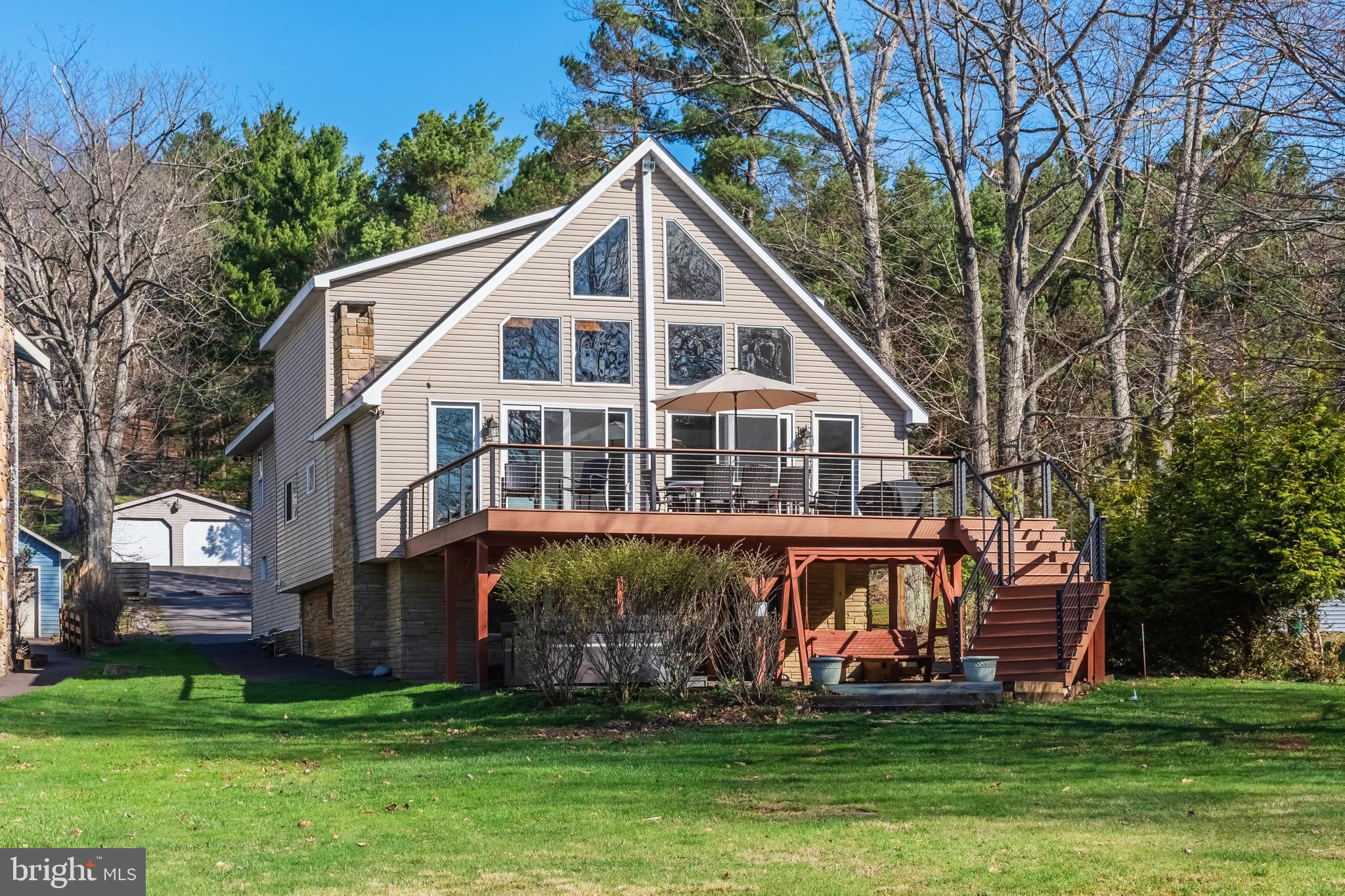 Escape to this charming lakefront retreat “Linger Longer” featuring a private type “A” dock, level waterfront, and stunning water views. Offering five bedrooms, an open floorplan, great loft area, and a game room, this home has plenty of space to spend time with family and friends. Enjoy peaceful mornings by the lake, afternoons on the water, and evenings in the hot tub and by the fire. The outdoor space includes a spacious lakefront deck that is perfect for simply unwinding after a day of boating, fishing, and enjoying all that Deep Creek Lake has to offer. The rear lot includes detached garage space for all your recreational toys. There is also a whole-house generator in the event you would need backup service.  Recent updates include new roof, new deck and sliding doors, full interior painting, remodeled kitchen and baths and a water purification system. Glen Cove is a coveted spot at the lake, and this home is at the end of a dead-end road, providing excellent privacy. And the centralized location puts you super close to restaurants, shopping, cinema, coffee shops, DCL State Park, and golf courses.