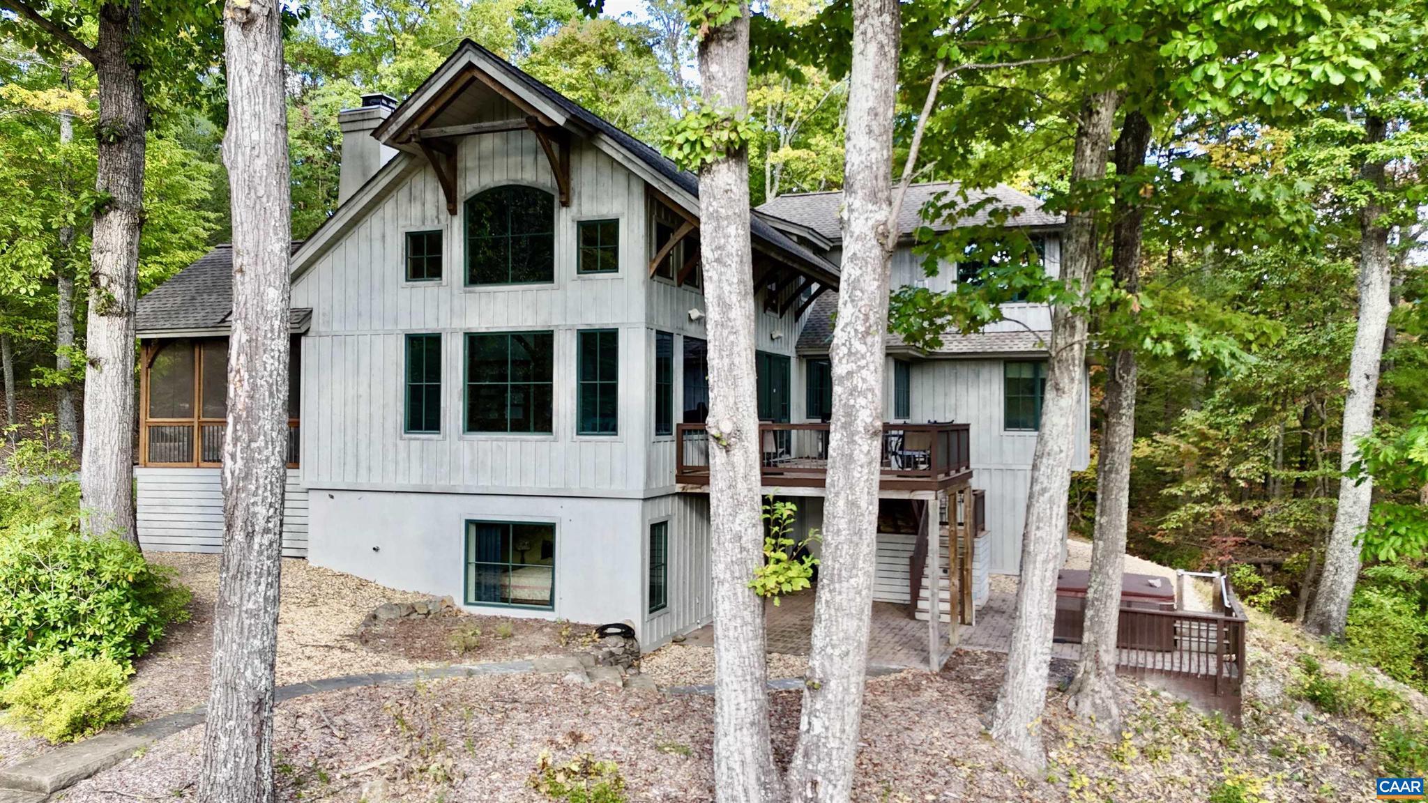 The Point   A remarkable post & beam home perched on a scenic knoll above 250 feet of frontage on the Moormans River. Enjoy the mountain views from this private retreat near the Sugar Hollow Reservoir and the Shenandoah National Park. This custom-designed home was constructed by Smith & Robertson, Inc. The great room boasts a beautiful 22-foot timber frame cathedral ceiling with stone fireplace with raised hearth, and a wall of windows, taking full advantage of the expansive Blue Ridge Mountain views. An elevator services three levels of living, complemented by extraordinary outdoor living spaces; screened porch, decking and patios. The board & batten exterior with architectural dimensional shingles blends harmoniously with the canopy of mature hardwoods. The property features a large two-car garage with stairs to unfinished space above. There is a pool and hot tub with outdoor shower, fenced raised garden beds and potting tables, all enhanced by the professional landscape design by Bill Mauzy of Three Ridges Landscape Architecture. This property is truly a work of art with a setting that won't disappoint. House generator, central vacuum system, custom lighting and sculptured water fountain are a few of the fine features.,Glass Front Cabinets,Granite Counter,Solid Surface Counter,Fireplace in Living Room,Fireplace in Study/Library
