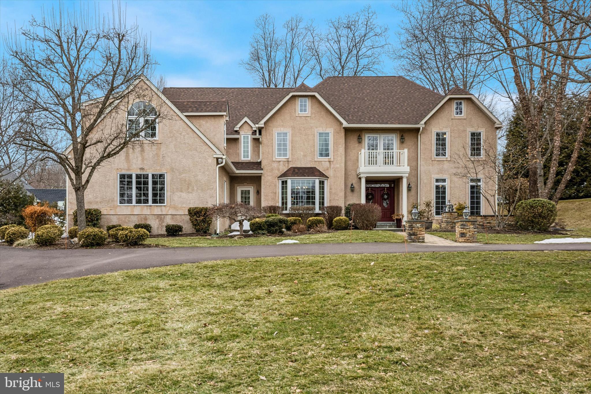Welcome to 839 Foxfield Road, nestled in Foxfield Reserve, one of Lower Gwynedd’s most desirable and pedestrian-friendly luxury communities. Step into timeless elegance in this magnificent 5-bedroom, 6 full bath, 1 half bath residence, thoughtfully designed for both everyday living and exceptional entertaining. A grand two-story foyer welcomes you inside, highlighted by a dramatic spiral staircase that serves as a stunning architectural focal point. To the right, the formal living room offers incredible versatility. French doors divide the space into two distinct areas and, paired with a full bath, create the perfect flexible suite for a home office, library, or creative studio. To the left, the formal dining room provides an elegant setting for gatherings and flows seamlessly into a butler’s pantry that leads to the spectacular chef’s kitchen. The gourmet kitchen features stainless steel appliances, a 5-burner gas cooktop, two warming drawers, and a custom window above the sink that frames beautiful backyard views while filling the space with natural light. Just beyond, the sun-filled Florida room with radiant heated floors offers a serene retreat ideal for year-round enjoyment, morning coffee or plant lovers. A versatile bonus room off the kitchen can function as a walk-in pantry, mudroom extension, pet room, yoga studio, or children’s zone. At the rear of the home, a functional wing includes the laundry room, garage access, an additional exterior entrance, and a secondary staircase to the second level. The main level is anchored by the expansive family room, where vaulted ceilings, a wood-burning fireplace, and dramatic floor-to-ceiling windows create a warm, inviting atmosphere. The open layout allows the kitchen and family room to flow effortlessly together, perfect for everyday living. Upstairs, the luxurious primary suite is privately situated and features a separate sitting room, two walk-in closets, and a spa-inspired bath with jetted soaking tub, dual vanities, and walk-in shower. Bedrooms two and three each include private en suite baths, while the fourth bedroom—added in 2020 above the garage—functions as a private in-law or au pair suite, complete with its own sitting area and full bath. A second-floor stackable washer and dryer adds everyday convenience making laundry easily accessible where it’s needed most. The fully finished lower level provides exceptional flexibility. Here you’ll find the fifth bedroom with a full en suite bath, along with a dedicated entertaining area featuring countertops and a sink, ideal for game days or movie nights. Two expansive additional spaces offer room for a family room, office, fitness studio, playroom, or media area, while finished storage areas keep seasonal décor, sports equipment, or a wine collection neatly organized without sacrificing living space. Set on nearly an acre, the backyard offers a private fenced retreat with space for gardening, play, and outdoor entertaining. The centerpiece is a beautiful in-ground saltwater pool, added in 2008, creating the perfect summer oasis. Major updates include a new roof (2025) and HVAC systems updated in 2015 (attic) and 2018 (basement). Located in the Wissahickon School District and minutes from top private schools, this home offers exceptional convenience to Routes 309, 202, 276, and I-476, with regional rail nearby. Just minutes away, Ambler offers charming boutiques, acclaimed restaurants, lively First Friday events, and a beloved Saturday Farmers Market. Homes in Foxfield Reserve rarely become available—and when they do, savvy buyers know they don’t last long. Book your showing today and be sure to check out the virtual tour as well!