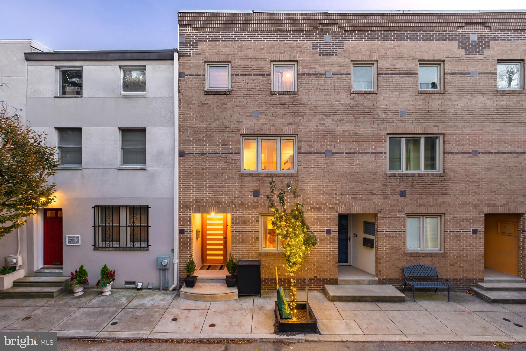 Located on a quiet and tree-lined block, 2010 Naudain Street is a meticulously crafted 3-bedroom, 2.5-bathroom townhome spanning approximately 2,600 square feet. Originally designed by esteemed architect, Adele Naude Santos, this wonderfully laid out home was re-built; boasting all new wiring, plumbing, and finishes evoking a sense of calm, beauty and open air and light all throughout the space. Entering on the first floor, you’re welcomed into a thoughtfully designed space with a dedicated dining area, living space and a high-end kitchen outfitted with premium appliance, quartz counter-tops, undercabinet lighting and an abundance of storage space. The kitchen’s open layout extends vertically, creating a dramatic visual connection all the way up to the third floor. This unique vertical open concept allows natural light to flood the home, enhancing its airy and expansive feel. On the second floor, a large family space was created and built with a gas burning fireplace, a custom entertainment built-in, and glass railing that adds warmth and elegance, and overlooks the kitchen and dining area below.  Each bedroom on this level has its own closet space, LED lighting, great ceiling height and access to the second bathroom. You will also find a fully built-in laundry room with storage on this floor. Up the stairs is home to the primary suite with a walk-in closets fabricated by California Closets, a large primary bathroom that is well cared for and both clean and minimal, and an office space. The roof deck is also on the third floor and is pristine, very private and great for hosting large gatherings. Completing this exceptional home is a parking garage off the rear with plenty of additional storage space. A second space is available at the lot on the corner for $360 per month. Located in one of Center City’s premier neighborhoods, 2010 Naudain offers proximity to many local restaurants, shops, parks, markets and all the City has to offer.