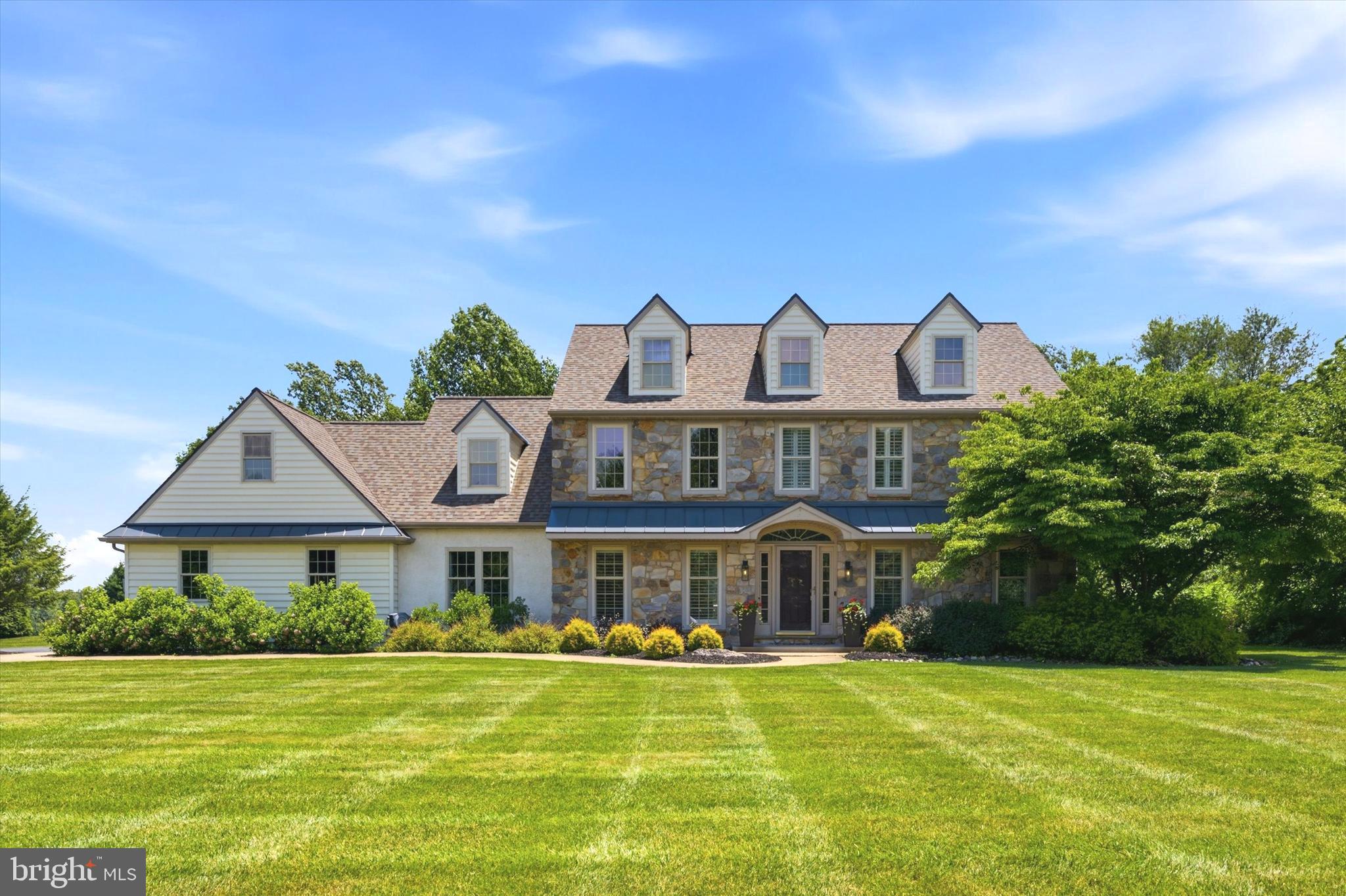 **IN-LAW SUITE WITH PRIVATE ENTRANCE AT MAIN LEVEL **
Welcome to 103 Raintree Lane; a stunning 5 bedroom, 3-1/2 bathroom modern-yet rustic Cedar Knoll  built Farmhouse nestled on a beautifully landscaped, flat and fenced 1.3 acres in sought-after Avon Grove School District.  This nearly 3700 square foot beauty exudes amazing curb appeal from its charming “third story” dormers to the REAL STONE front facade.   Step inside to discover a 2-story foyer with classic turned oak staircase, hardwood floors which continue into the living, dining and family rooms.   The bright kitchen showcases quality upgrades that will inspire your culinary creativity, while the freshly painted main house creates a bright, move-in-ready canvas for your memories.  The main level offers an exceptional layout that includes a thoughtfully designed in-law suite, providing the perfect solution for multigenerational living or welcoming guests with privacy and ease.  Brand new second-floor carpeting adds luxurious comfort underfoot in the spacious bedrooms and elegant plantation shutters throughout enhance both style and privacy.   Loaded with natural light as well as an abundance of LED recessed lighting throughout.    The expansive flat lot provides endless possibilities for outdoor activities, gardening, or simply enjoying life in your own private sanctuary.   This rare combination of generous living space, modern updates, and peaceful setting is sure to please. Don't miss this opportunity to make 103 Raintree Lane your forever home—schedule your private showing today and see how effortlessly this home can fit your next chapter.