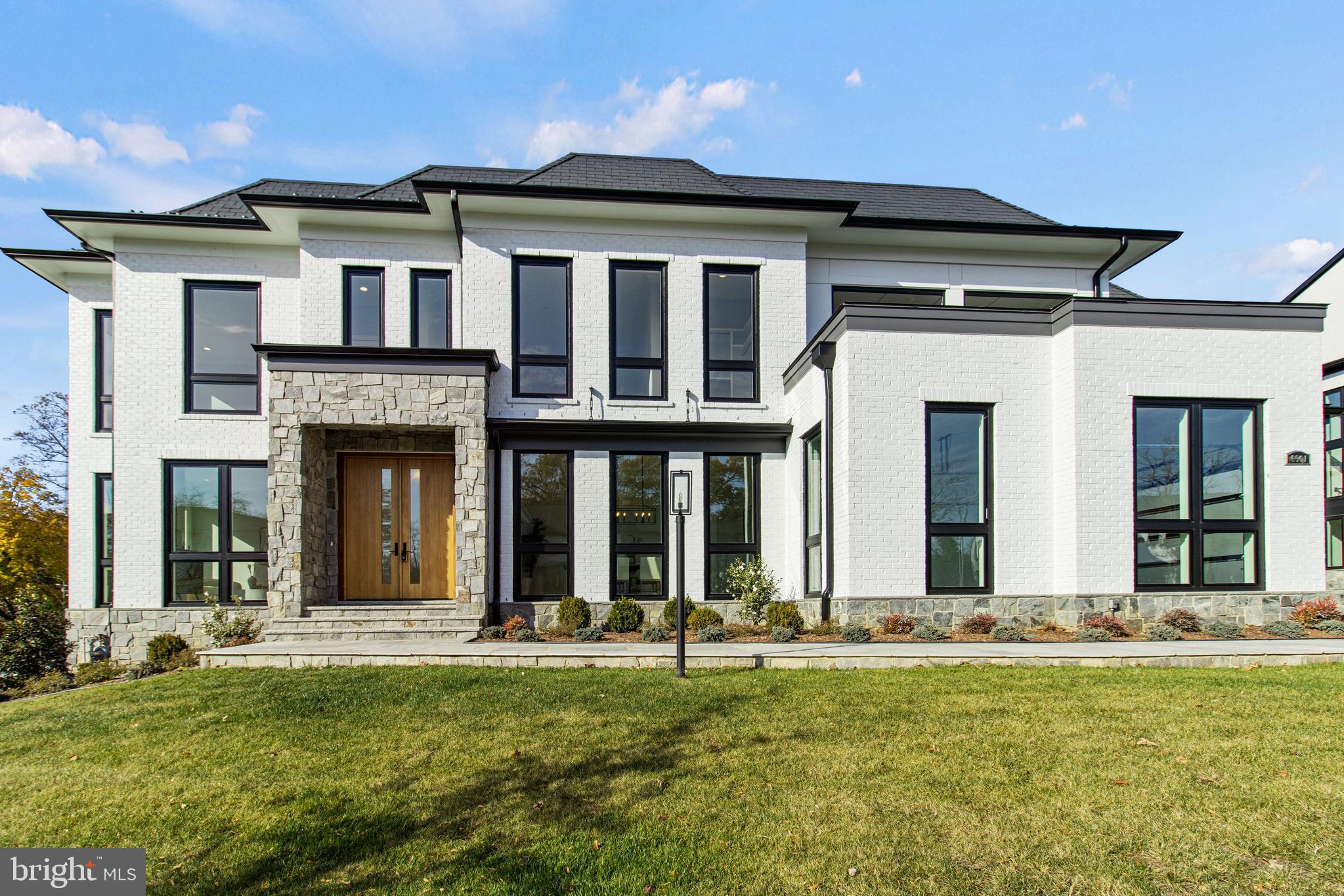 Move in Ready! Certificate of Occupancy in hand!
Nestled in an exclusive enclave of eight luxury residences, this stunning new home merges convenience with unparalleled sophistication. Located a stone's throw from downtown McLean, Tysons Galleria, and the Metro, this property boasts approximately 10,305  sq ft of opulent living space across three levels including the outdoor living areas.
This spectacular brand-new home is ready for the most discerning Buyer, one who appreciates superb quality and incredible design. Nestled in the prestigious heart of Mclean is our Halls Manor Community. The only new construction community in Mclean.
Premier Homes proudly presents the impressive Onewood model that stands as a distinct and singular offering within the neighborhood, boasting a unique combination of transitional and modern architectural styles that set it apart from conventional Virginia homes.
Upon arrival, a stone-clad pathway marks the entry to this remarkable 7,828 square feet of living space spread across three finished levels. The home comprises 5 bedrooms, 7 baths, a gym, spa, 2 outdoor kitchens, a functional elevator, and a spacious 3-car garage. The Onewood model embodies elegance and functionality, featuring a striking formal living room, a spacious dining room, and a well-appointed open floor plan family room adorned with signature floor-to-ceiling windows, bathing the interiors in natural light. Leading from the family room, a delightful retractable screened porch awaits, complete with a double-sided fireplace, seamlessly connecting to an expansive deck and featuring a full outdoor kitchen with a grill, sink, refrigerated drawers, and Deckton countertops, setting the stage for seamless outdoor entertaining.
The stunning kitchen serves as a central hub for relaxation and gatherings, boasting a large quartz waterfall island ideal for presenting culinary delights or accommodating casual meals. Complete with two dishwashers, a pot filler over the 6-burner gas stove, stainless steel appliances, and a prep-area pantry with a separate sink, this kitchen offers the perfect setting for family and friends to gather for holidays or special occasions, with its seamless connection to the family room and outdoor deck. Adjacent to the kitchen, a mudroom and storage closets lead to the 2-car and 1-car garages, ensuring practicality and organization.

Ascending to the upper level, meticulous attention to detail adorns 4 bedrooms, with a grand hallway featuring decorative ceiling details, offering a sense of refined elegance throughout the residence. Each bedroom is designed to provide comfort and luxury, catering to family living or hosting guests with style and grace. The Owner's suite which is a true retreat featuring a private terrace overlooking the community with retractable screens. The suite also features a wet bar, sitting room with a double-sided fireplace and room for a study. The spa bath has a beautiful stand-up steam shower with the bathtub inside to connect the two into one spa like space that immediately captures your attention. Two toilet rooms and two large walk-in closets, one with an island.
The lower level is surrounded by windows creating a non-like basement feel. It accesses the rear stone terrace with yet another full outdoor kitchen and outdoor fire table which gives you the opportunity for ample space for entertaining. Fully fenced back yard. Lower Level also features full wet bar including a dish washer, microwave and beverage fridge. Behind the bar is the tasting room with plenty of space for all your wines and fine beverages.
In summary, this unparalleled property exemplifies the pinnacle of modern living, with a unique blend of luxury, functionality, and exceptional design. Total sq. footage includes outdoor living and garages.