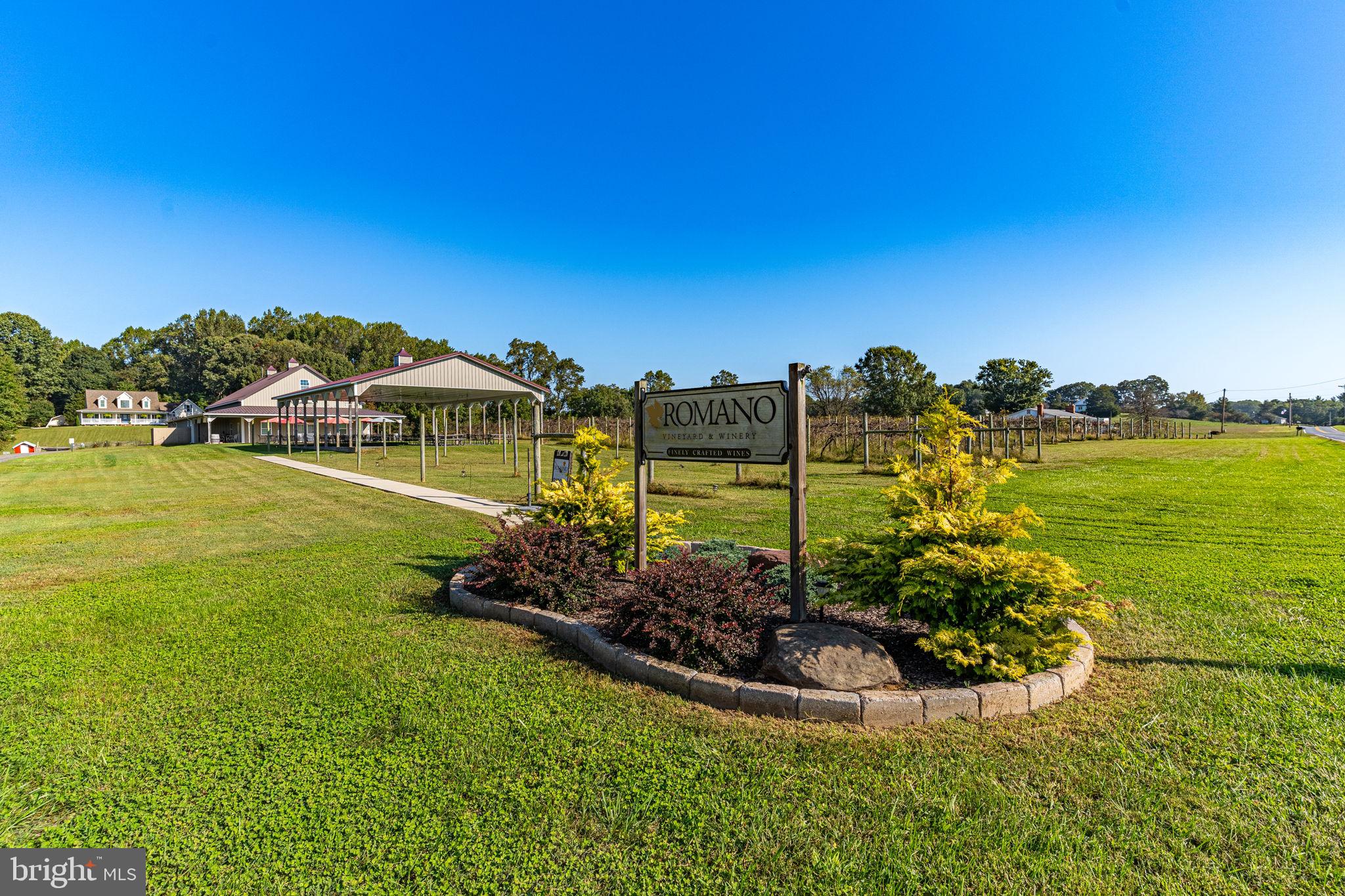 Nestled amidst the idyllic landscape of Brandywine, strategically positioned for easy access to Washington, DC, Virginia, and Southern Maryland, a truly unique opportunity awaits.

This is a rare and enticing chance to acquire the very first commercial winery in Prince George’s County, MD. Founded in 2007, Romano Winery has a storied history of profitability until its temporary closure to the public in June 2023. Now, the baton is passed to you, offering the opportunity to build upon the foundations of success and elevate this business to new heights.

The offering comprises three parcels spanning nearly 23 acres of picturesque, rolling terrain, complete with vineyards, woodlands, and open fields. Adding to the appeal is a 3,453 SF two-story custom home, offering 3 bedrooms and 3.5 baths with picturesque views. Inside, find exquisite wood plank flooring, a spa-like whirlpool tub, dual-zone heating, a finished basement, a sprawling deck, and a bonus room above the finished two-car garage. The kitchen is adorned with Corian countertops, custom cabinetry, new stainless appliances, and freshly installed LTV flooring. A 16’x20′ two-story shed and 50’x30’ workshop/pole barn enhance the property’s utility.

Descending from the residence, you’ll encounter a separate tasting room containing 2,300 SF plus prep kitchen and additional storage space. Attached to this space is a 40’x60’ Pavilion, providing patrons with a serene environment to savor the winery experience while gazing upon the vineyard’s beauty.

On the direct opposite side of Bald Eagle School Road lie two additional parcels with their own vineyards. Here, you’ll discover a purpose-built 40’x60’ production facility and an additional 65’x30’ pole barn/workshop, all designed to support the grape-growing and wine-making process.

The vineyard itself, initially planted in 2007 with additional plantings in 2017, boasts approximately 1,600 vines, including varietals such as Vidal, Chambourcin, Cayuga, Traminette, Viognier, and Petit Verdot. Over the years, the vineyard has yielded an average of 8 tons of grapes annually, with the benefit and flexibility of procuring additional grapes from partner vineyards.

In terms of production, this boutique winery has historically produced between 1,500-2,000 cases annually, with the potential to expand to 8,000+ cases within the existing facilities with additional equipment. The growth prospects are exciting, with opportunities to host weddings and events, explore wholesale distribution, and resurrect the once-popular wine club.

Romano Winery has a strong track record of profitability, and its prime location, nestled between two other wineries, and accessible to major metropolitan areas, positions it perfectly to re-establish itself as a prominent and sought-after winery destination under new ownership.

Embark on your dream of entering the thriving wine industry in Maryland. Romano Winery’s legacy of success and its strategic location await your vision and creativity. Don’t miss this chance to make your mark in the world of fine wines.

Additional photographs, business information, and private tours available upon the execution of a Non-Disclosure Agreement, and provision of verifiable Proof/Source of Funds letter directly from a recognized financial institution.