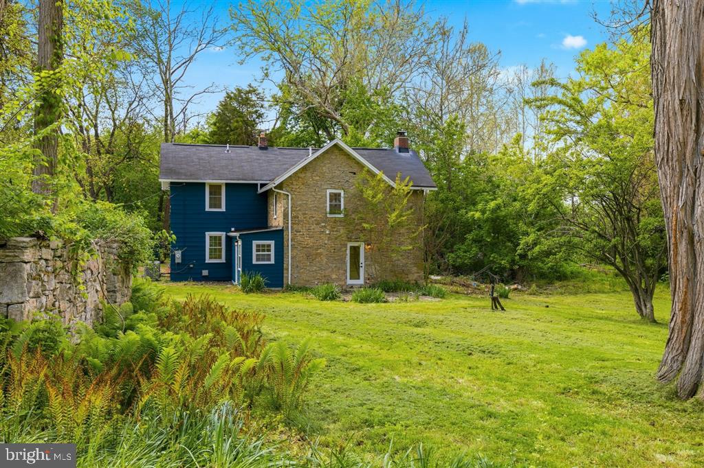 Next level renovation of a 1900 stone cottage set on a spectacular, impossibly private piece of land. Tucked so far off the beaten path you may have trouble finding it, this secluded Timonium gem sits on over an acre of lush, tree-canopied grounds where you will never see a neighbor. A creek winds through the property, and original historic features — including an old hand-operated water pump and the stone walls of an original one-room cottage — give this land a storybook quality that simply cannot be replicated. The yard is enormous, the privacy is absolute, and the setting feels worlds away from everything while being minutes from it all. The house itself has been completely gut-renovated from top to bottom — new plumbing, new electric, new HVAC system, new kitchen, new bathrooms, new porch, and new high-end finishes throughout — all while preserving the soul and charm of the original stone construction. True to its history, the home was originally built as a stone cottage and later expanded, and that heritage shows in the most charming way: a few steps down lead you from the newer addition into the original stone side of the house, where the walls are thick, the character is undeniable, and the feeling is something no new construction can touch. It is the kind of architectural detail that makes a house feel genuinely alive. The primary bedroom offers a generous, light-filled retreat. The original closet reflects the home's historic roots, and the seller is happy to either build out a second closet prior to closing or provide a $2,500 credit at closing — giving buyers the flexibility to customize the space exactly to their taste. Move right in. There is nothing left to do. A property like this — charming, private, creekside, and completely turnkey — is a once-in-a-decade find in Timonium. Don't let it pass you by.