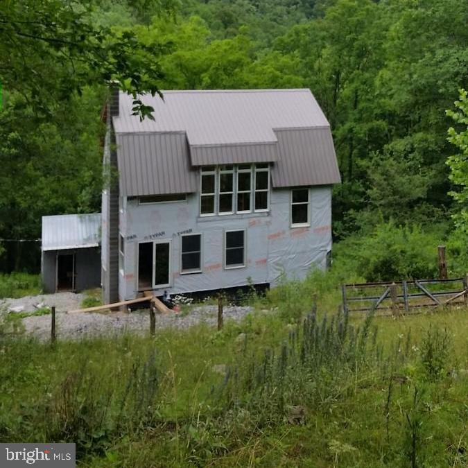 Imagine-no neighbors, total darkness for a gorgeous view of the WV night sky on 18 acres in the wilderness with a partially built house, you can customize the inside yourself!  This property features  a small cabin at the bottom of the property,  a wood shed or a place to store your ATV, another 2 store building for your supplies, tools, etc., the unfinished house and a small cabin/large hunting blind at the top that looks out at Dolly Sods.  There is a septic system onsite but not yet hooked to the house, electricity, phone/internet and a bountiful spring.  Would make a great hunting camp or vacation getaway.