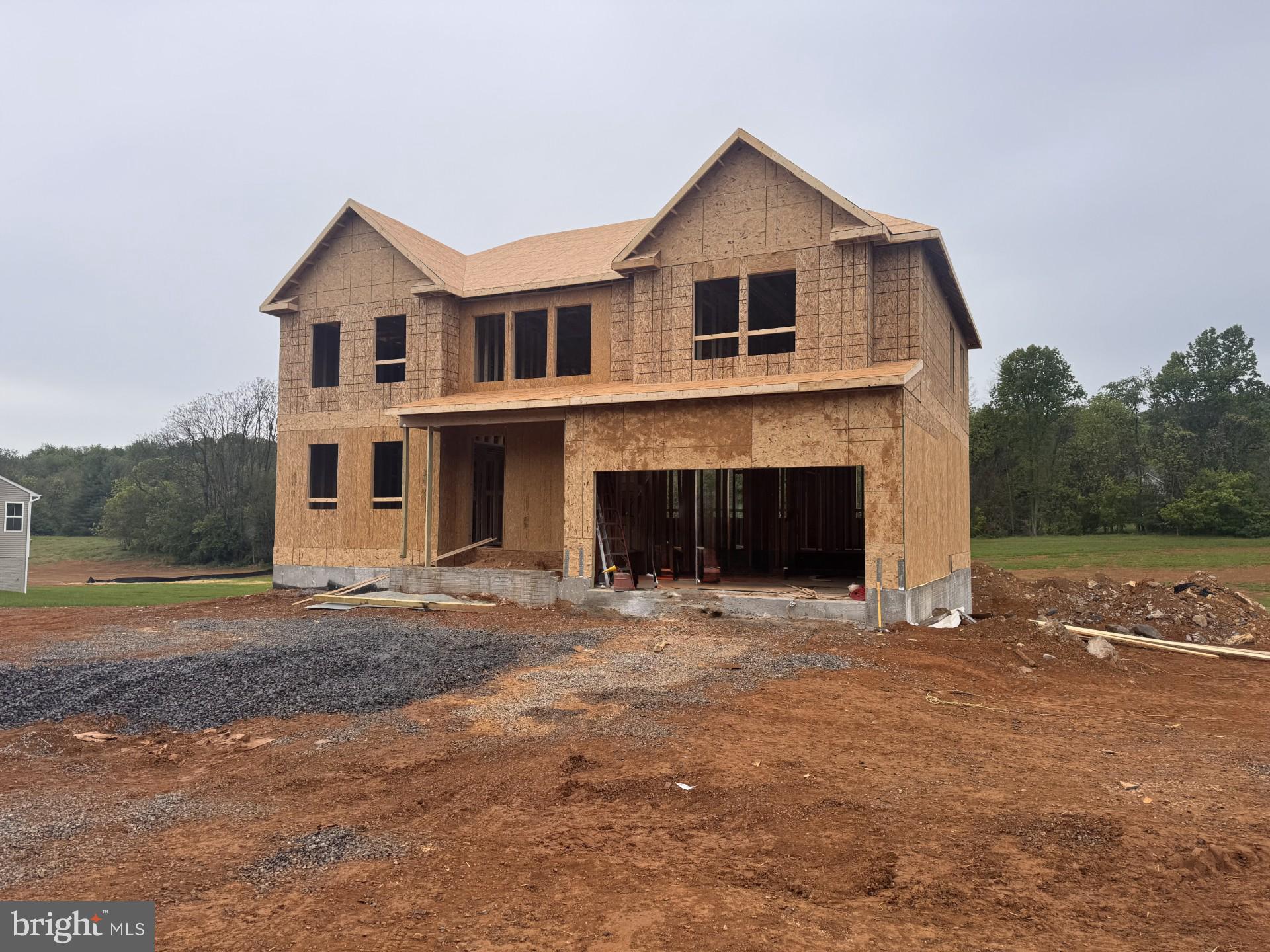 This home is in for under construction and estimated to be completed in August 2026! Welcome to Estates of Tuscarora, a highly sought after community offering 1+ acre homesites within close proximity to commuter routes, shopping, parks, and Historic Downtown Martinsburg! The Canterbury 2-story colonial home located on a homesite #35 on 1.38 Acres. This 2-car garage, 5-bedroom, 4 bath home blends timeless Farmhouse interior design with modern convenience! Offering an open floor plan, this home is perfect for both comfortable living and entertaining. At the heart of the home is an inviting family room with a gas fireplace, seamlessly connected to the kitchen and casual dining area. The well-appointed gourmet kitchen features GE Profile Stainless Steel appliances with range, hood vent, built-in wall oven and microwave; complete with a spacious island with quartz countertops and a farmhouse sink. A finishing touch on the main level is a rare find – an extra bedroom and full bath on the main level, ideal for guests, in-laws, or a home office. The 2-story foyer leads to a boxed oak staircase with an open railing, creating an elegant focal point leading to the upper level. The upstairs includes a loft area, 3 secondary bedrooms, laundry room and spacious Primary Bedroom. The Primary Bedroom includes a walk-in closet, tray ceiling, and luxury bath with a frameless shower door and free-standing soaking tub.  The additional finished recreation room and full bath in the basement complete this home for a total of 3.475 SF on a walk out homesite backing to trees. Don’t miss the opportunity to make this remarkable home your own! Call and schedule your personalized appointment today! Ask about our closing cost assistance with the use of KHovnanian American Mortgage! **Photos are of the decorated Canterbury Model Home and/similar home/features and may not reflect current home finishes. Pricing, options, and promotions are subject to change without notice. See Sales Consultant for more information**